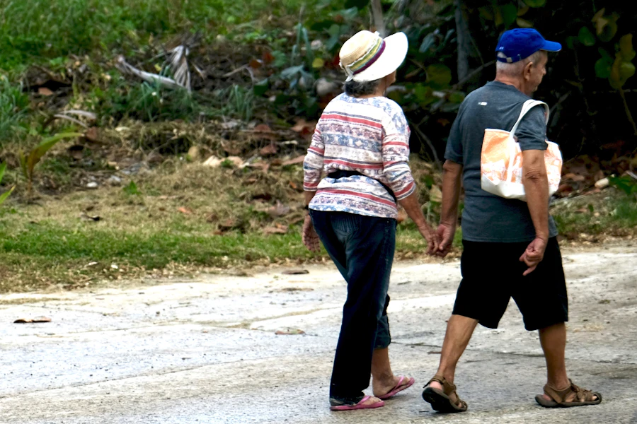 Retired couple walking hand in hand