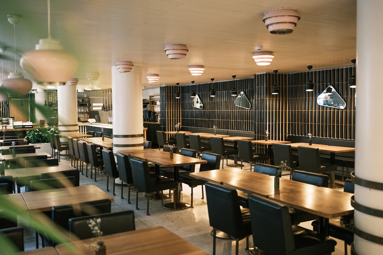 Empty modern restaurant interior with tables and chairs.