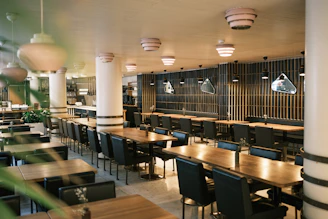 Empty modern restaurant interior with tables and chairs.