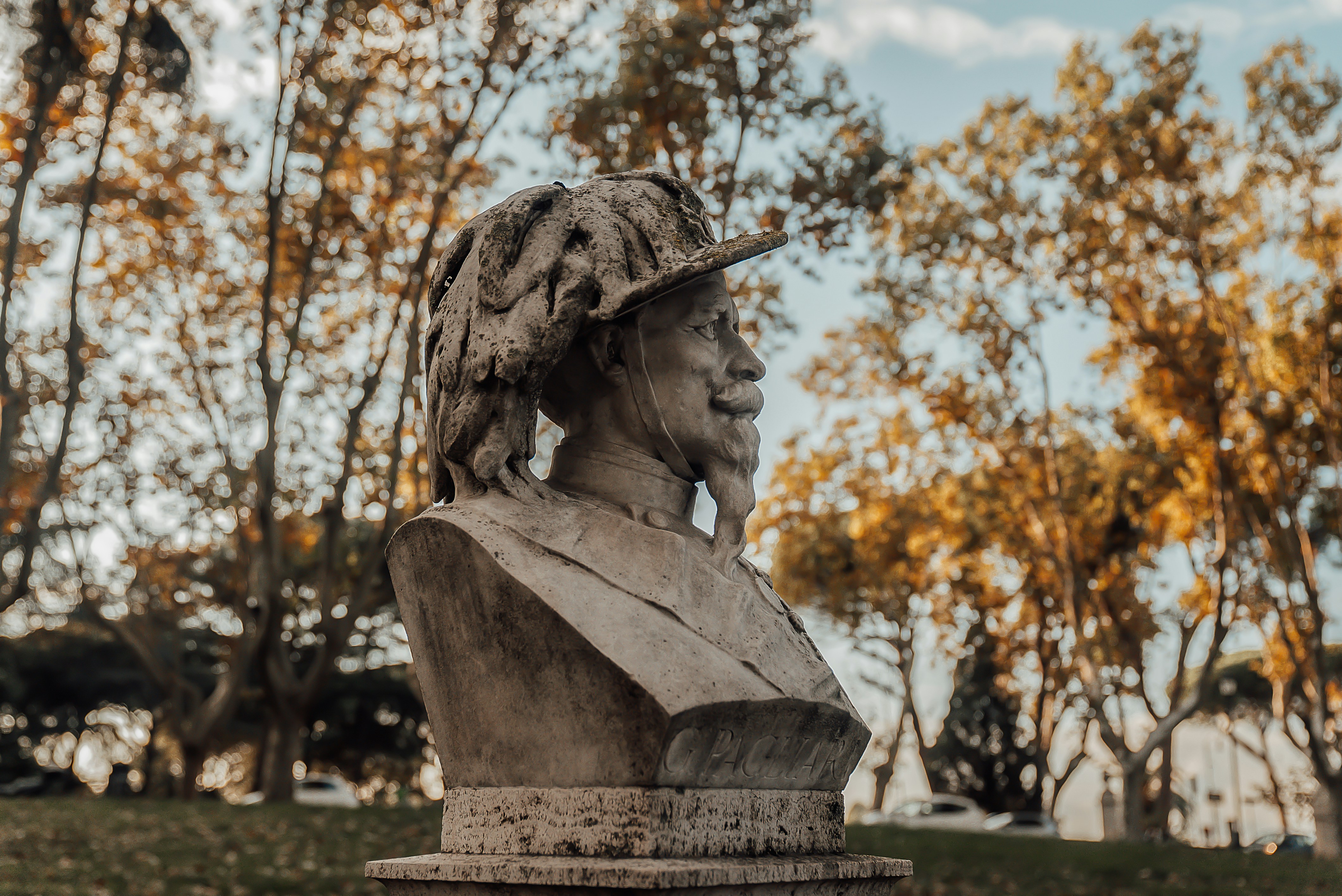Stone bust of a man with a feathered hat