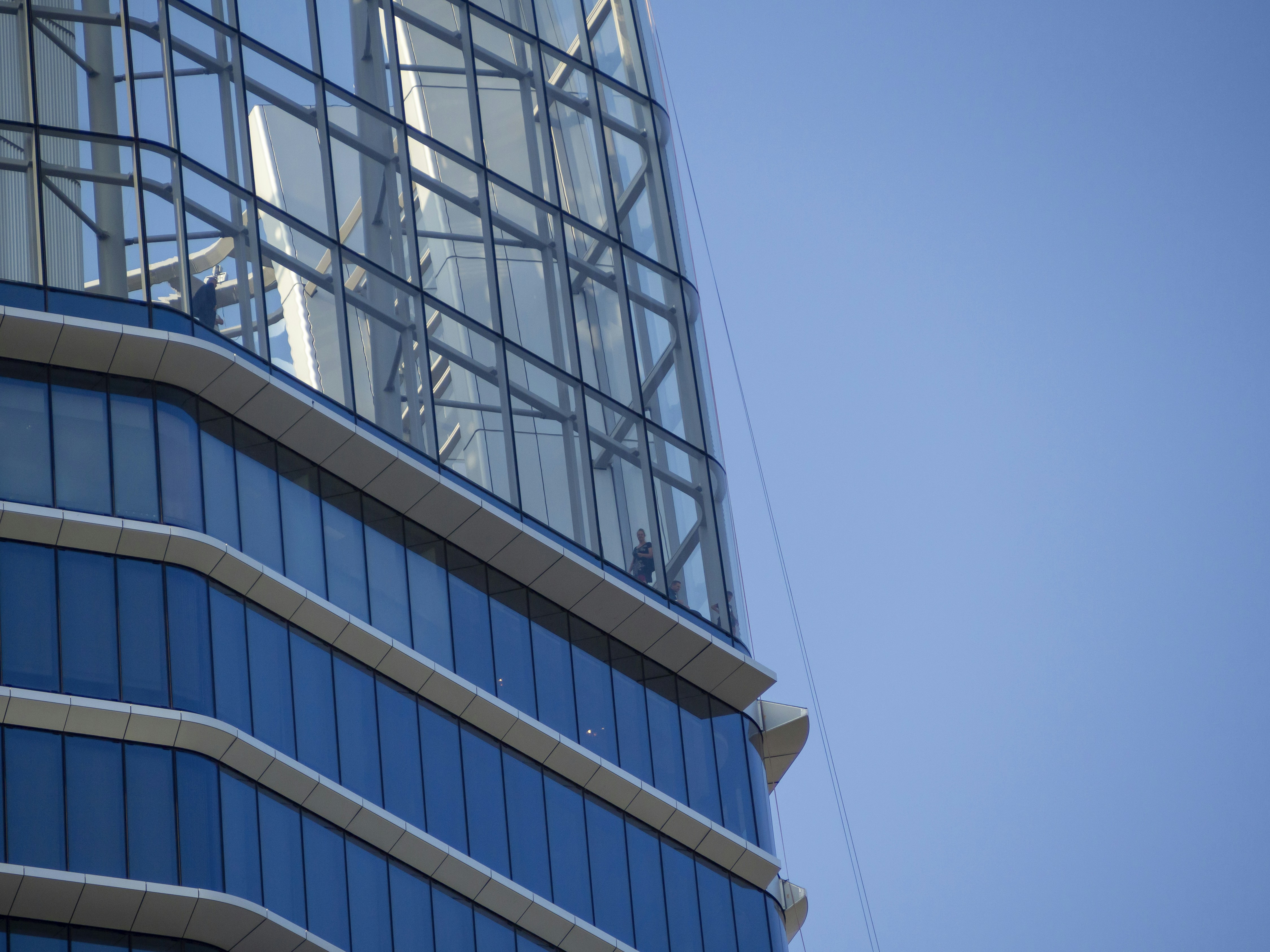 Daytime close-up and detailed shots of the MOL Campus in Budapest, highlighting its glass facade and modern architectural design.
