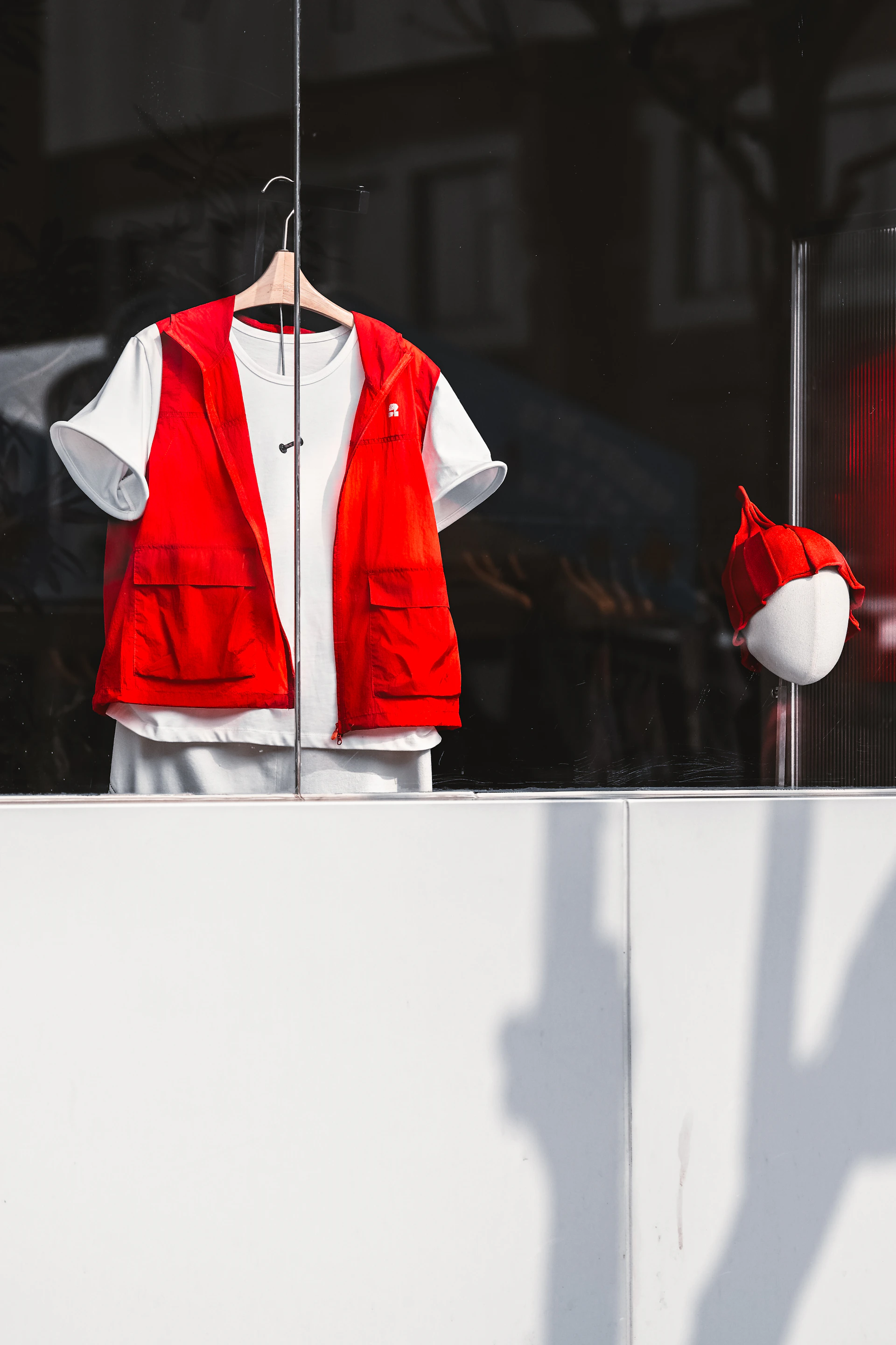 Red vest and white shirt displayed in window