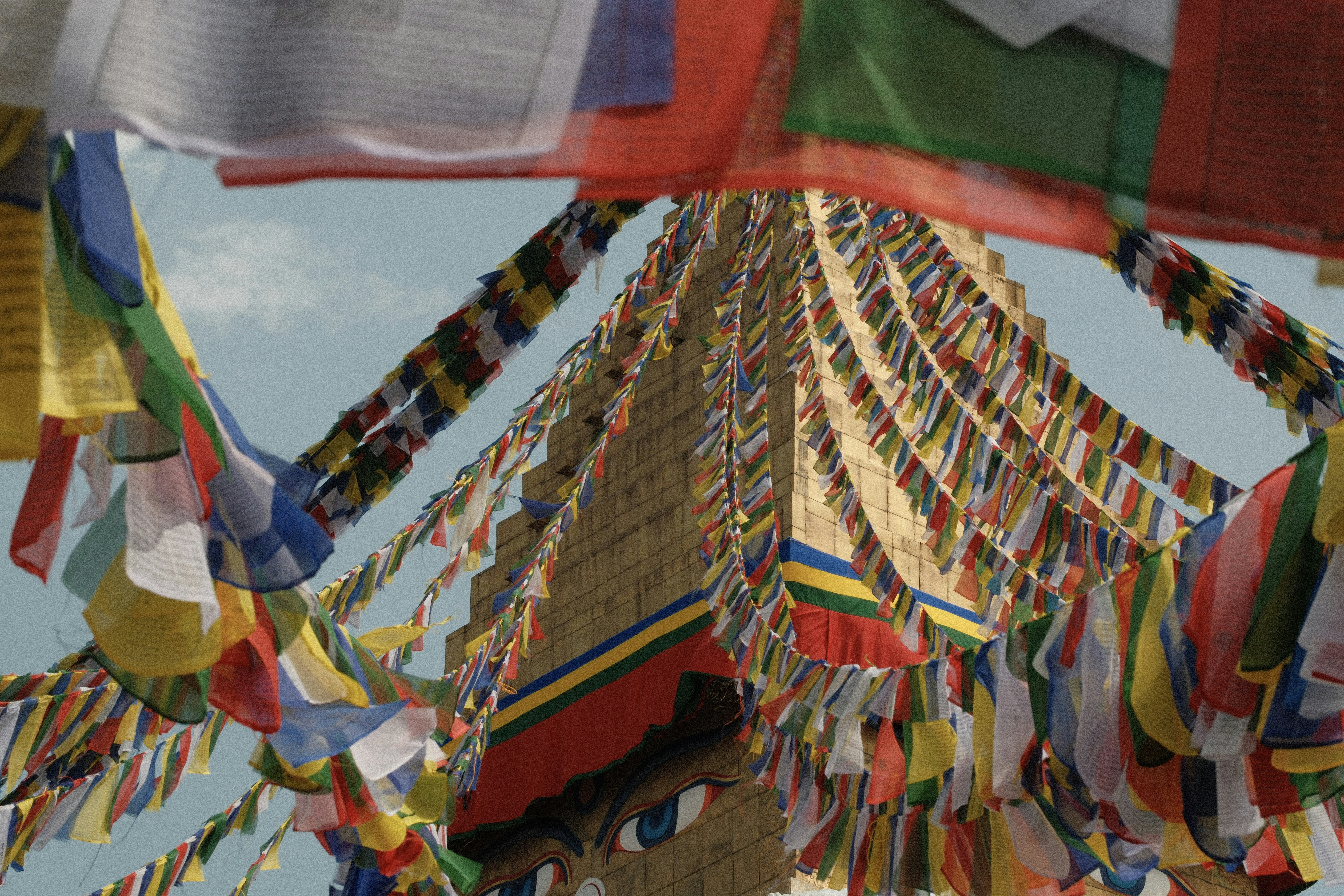 Colorful prayer flags strung around a stupa