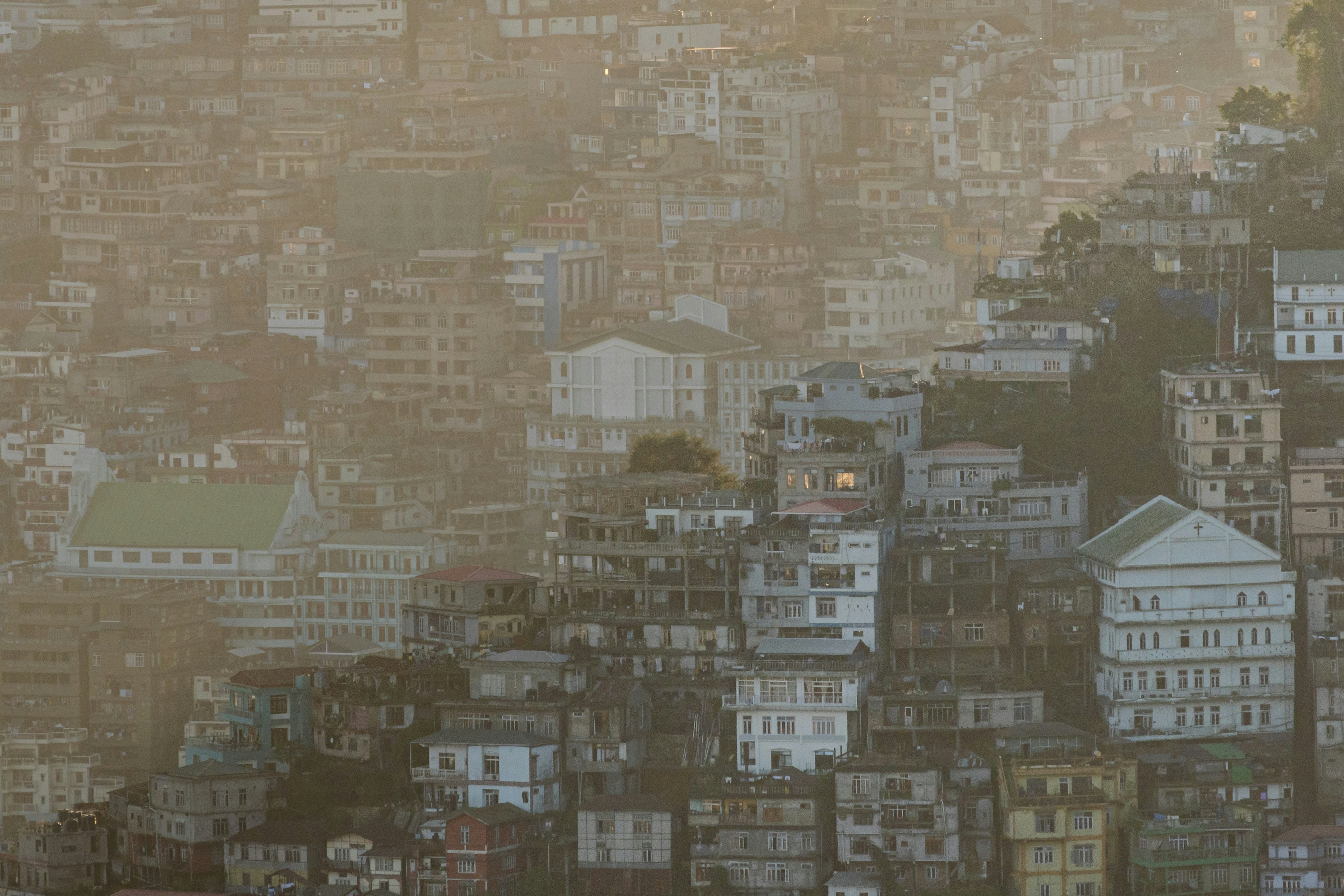 Dense cityscape on a hazy hillside