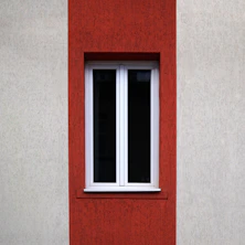 White framed window set in red and beige wall