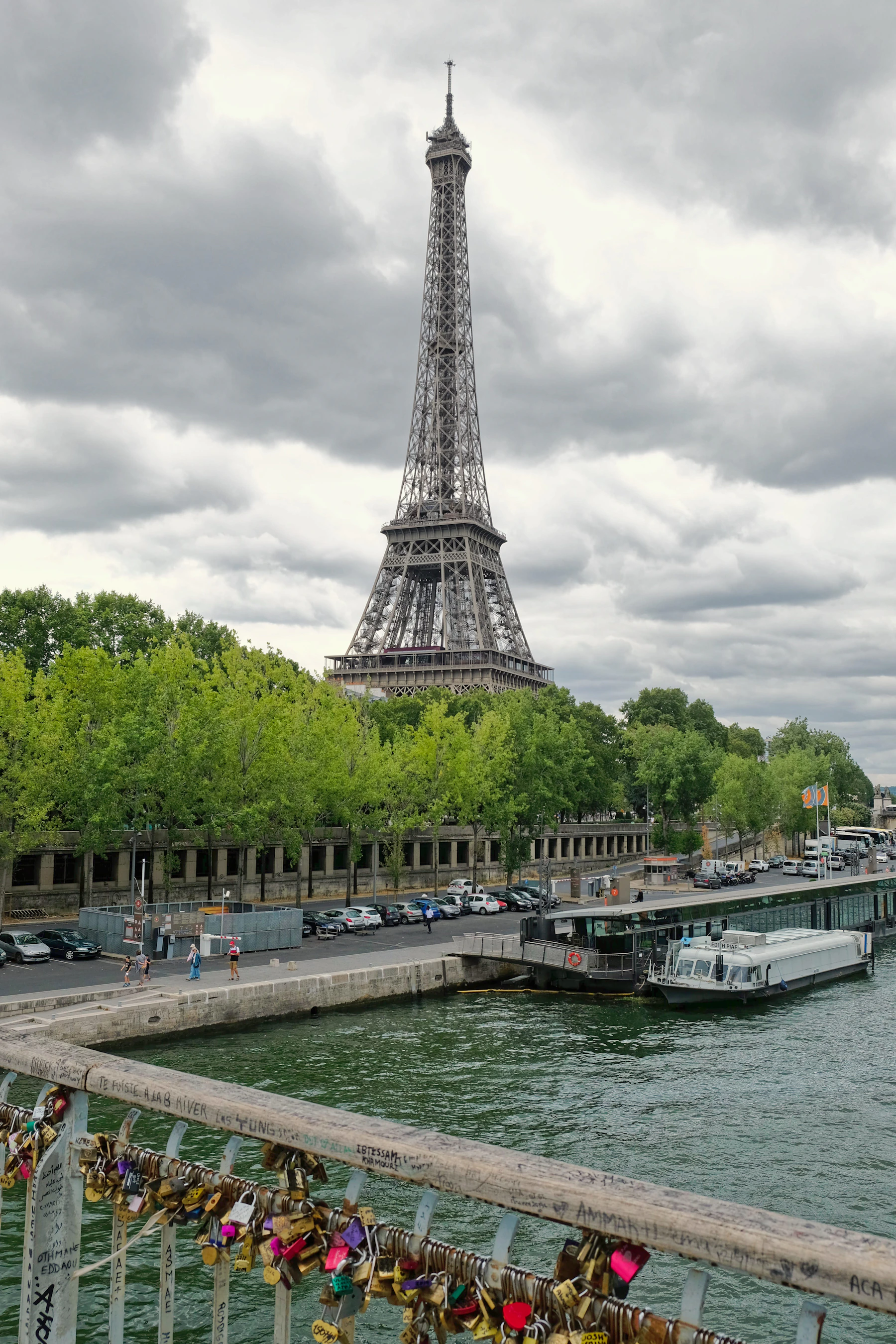 The Eiffel Tower rising above the River Seine and a Paris bridge