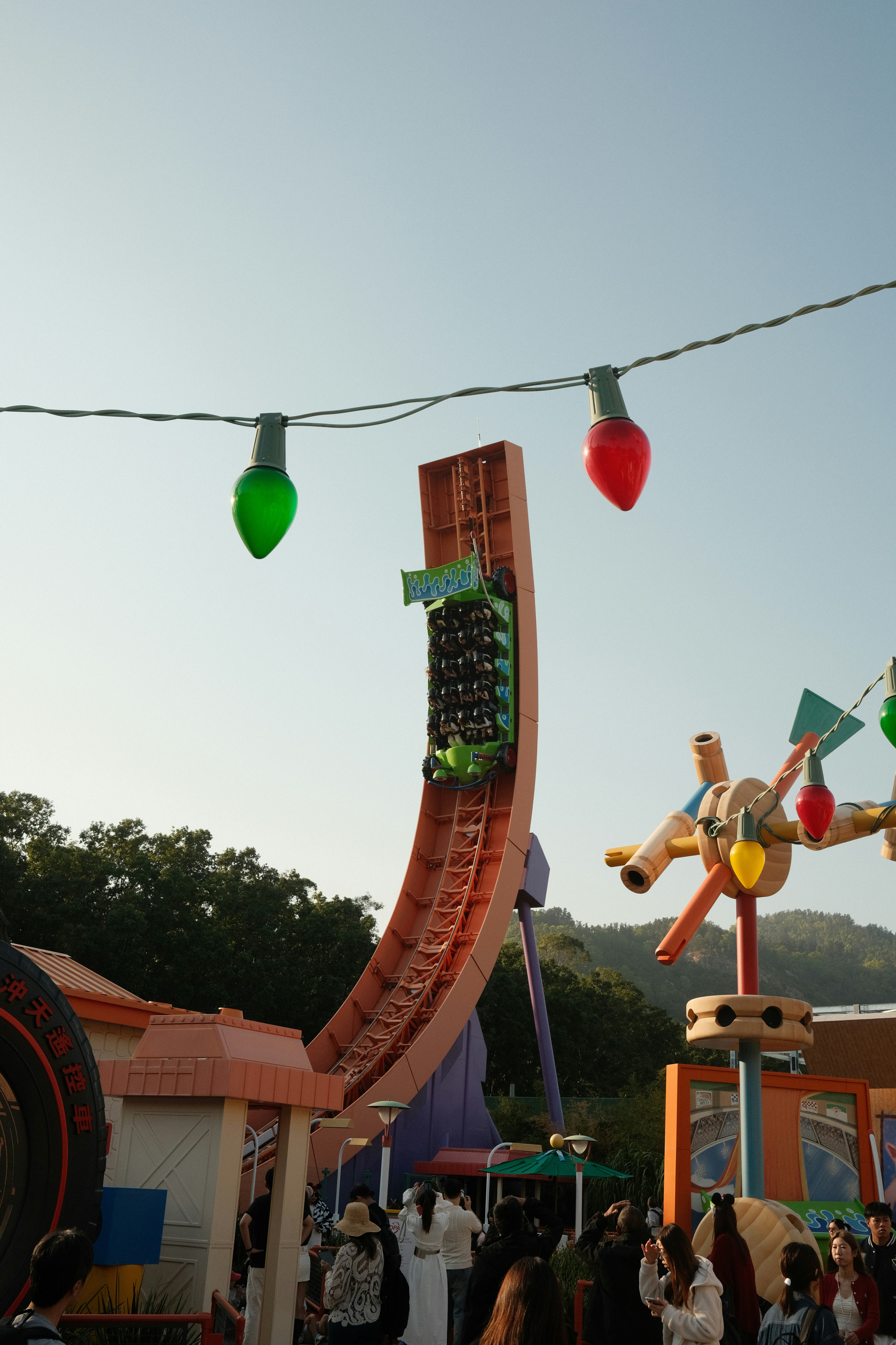 Roller coaster ride with colorful lights and people