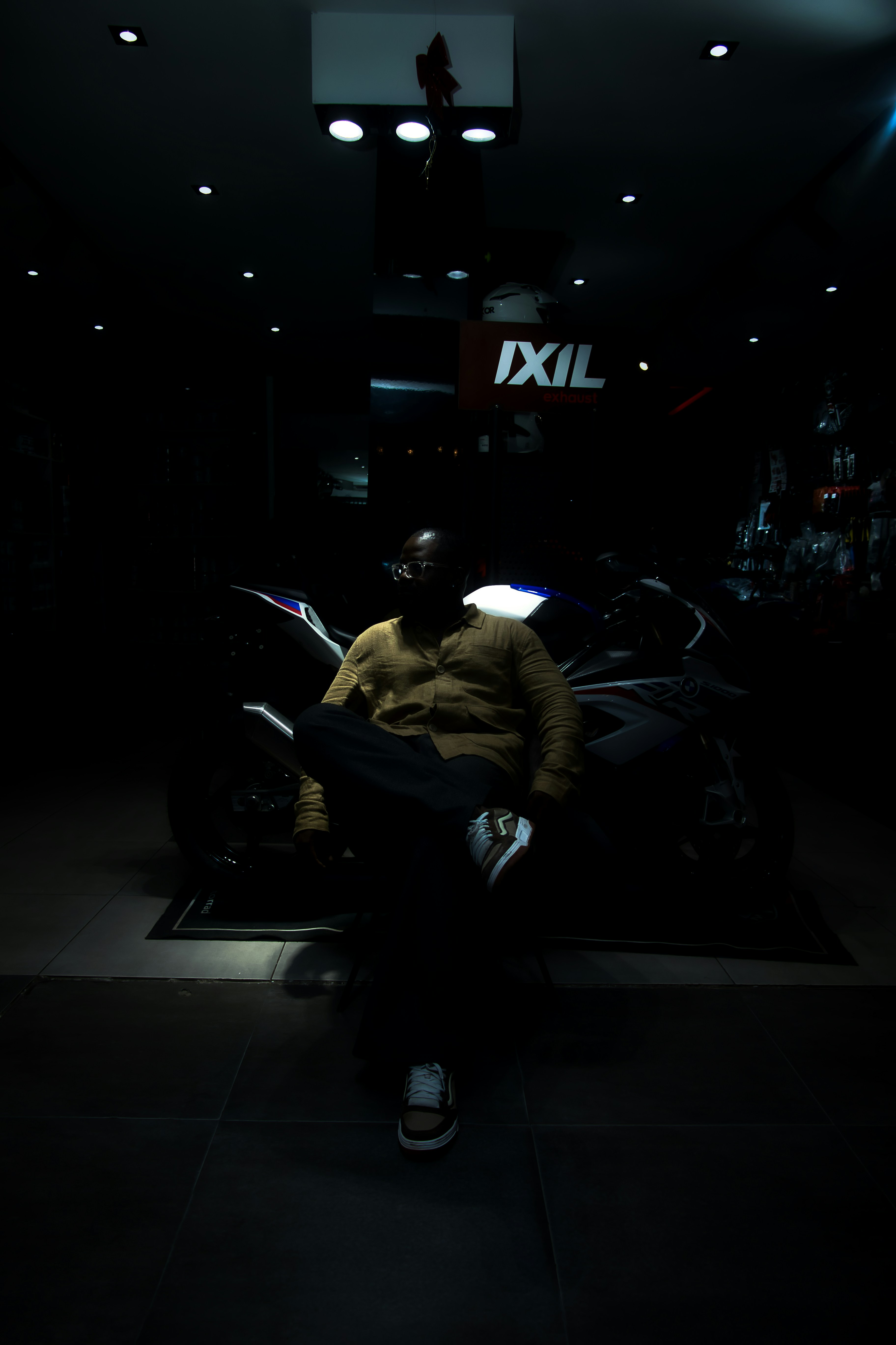 Man sitting in front of a motorcycle