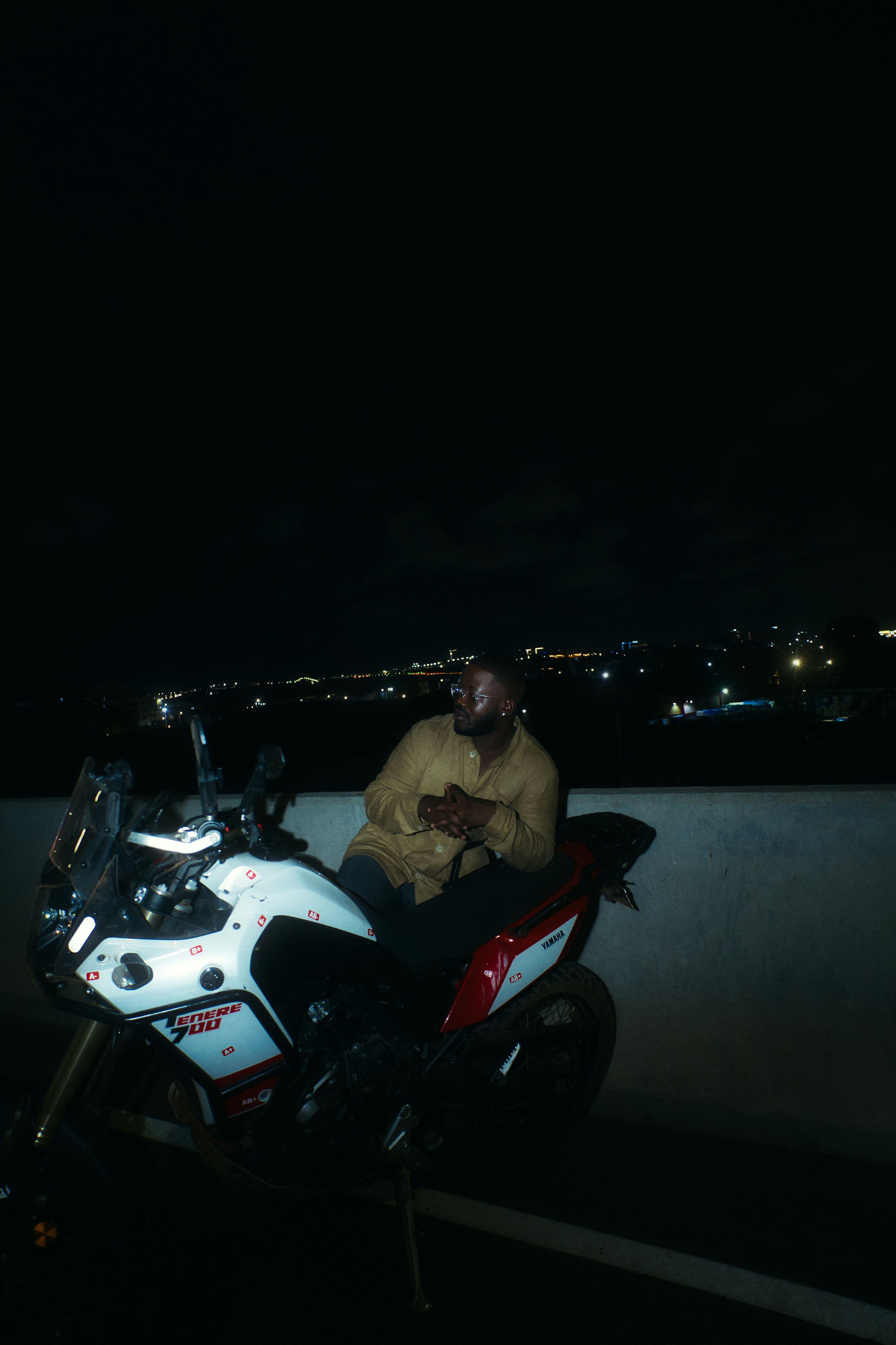 Man sitting on a motorcycle at night