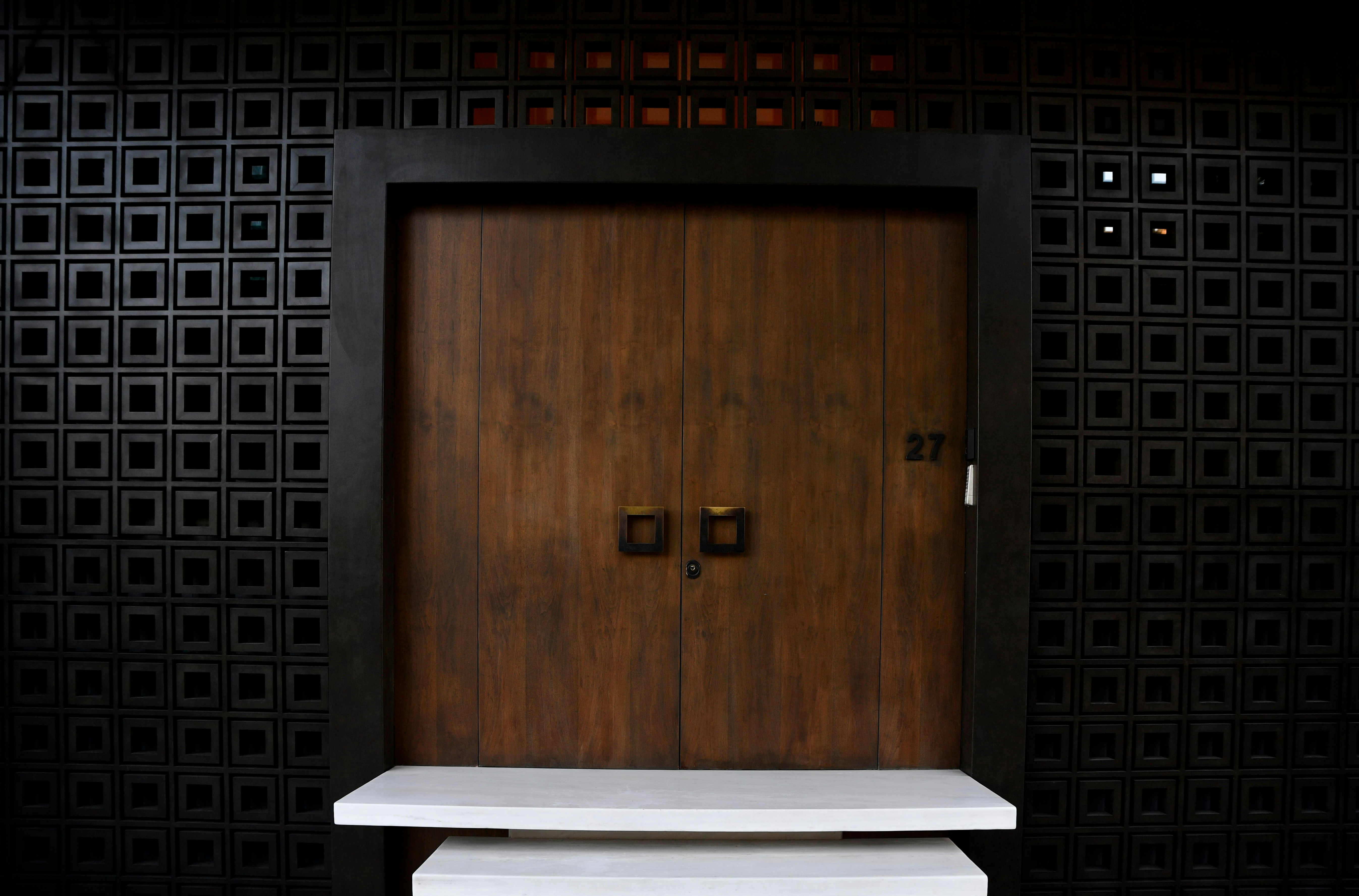Modern wooden door with square handles — a calm, secure entrance