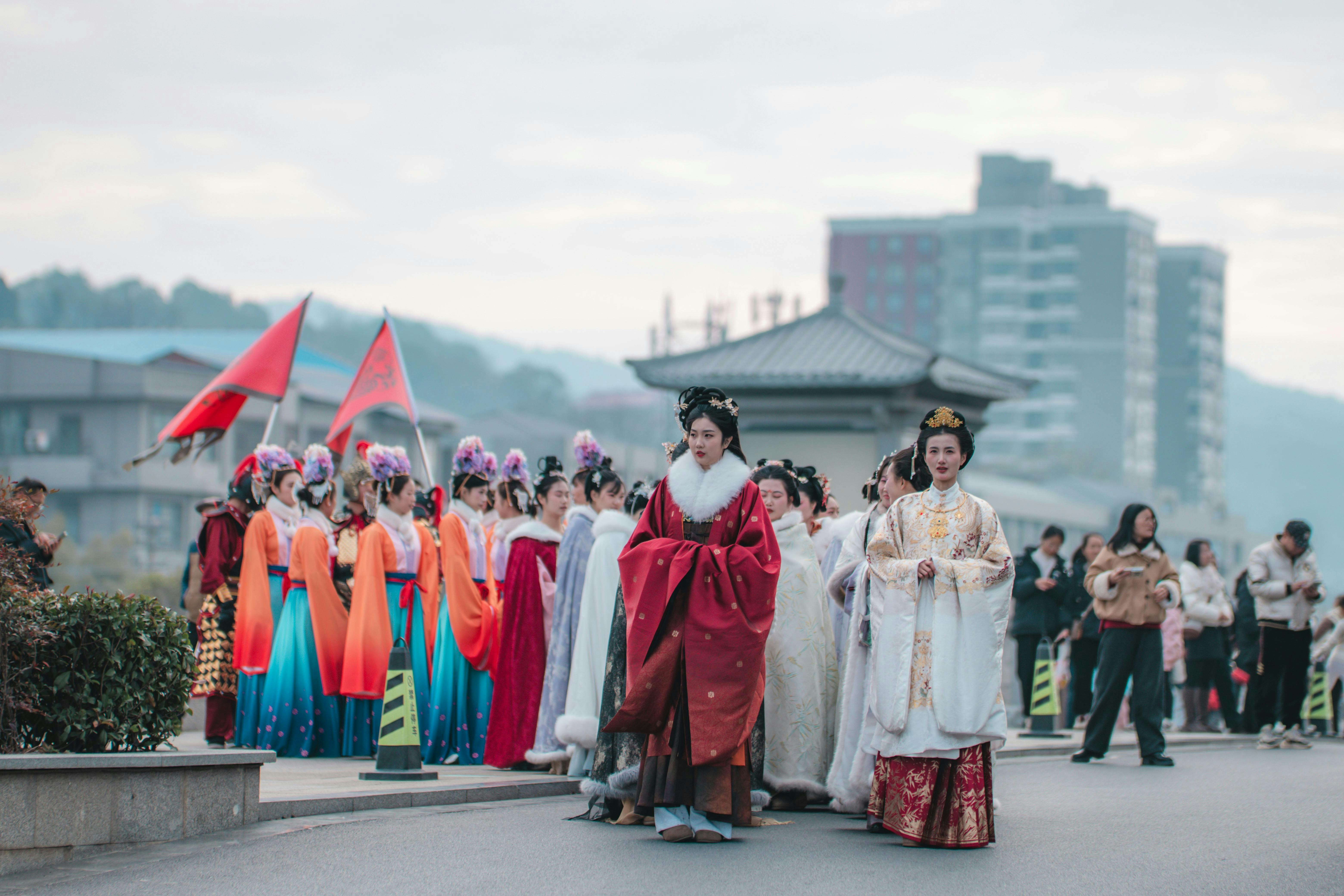 People in traditional chinese clothing walking in a procession