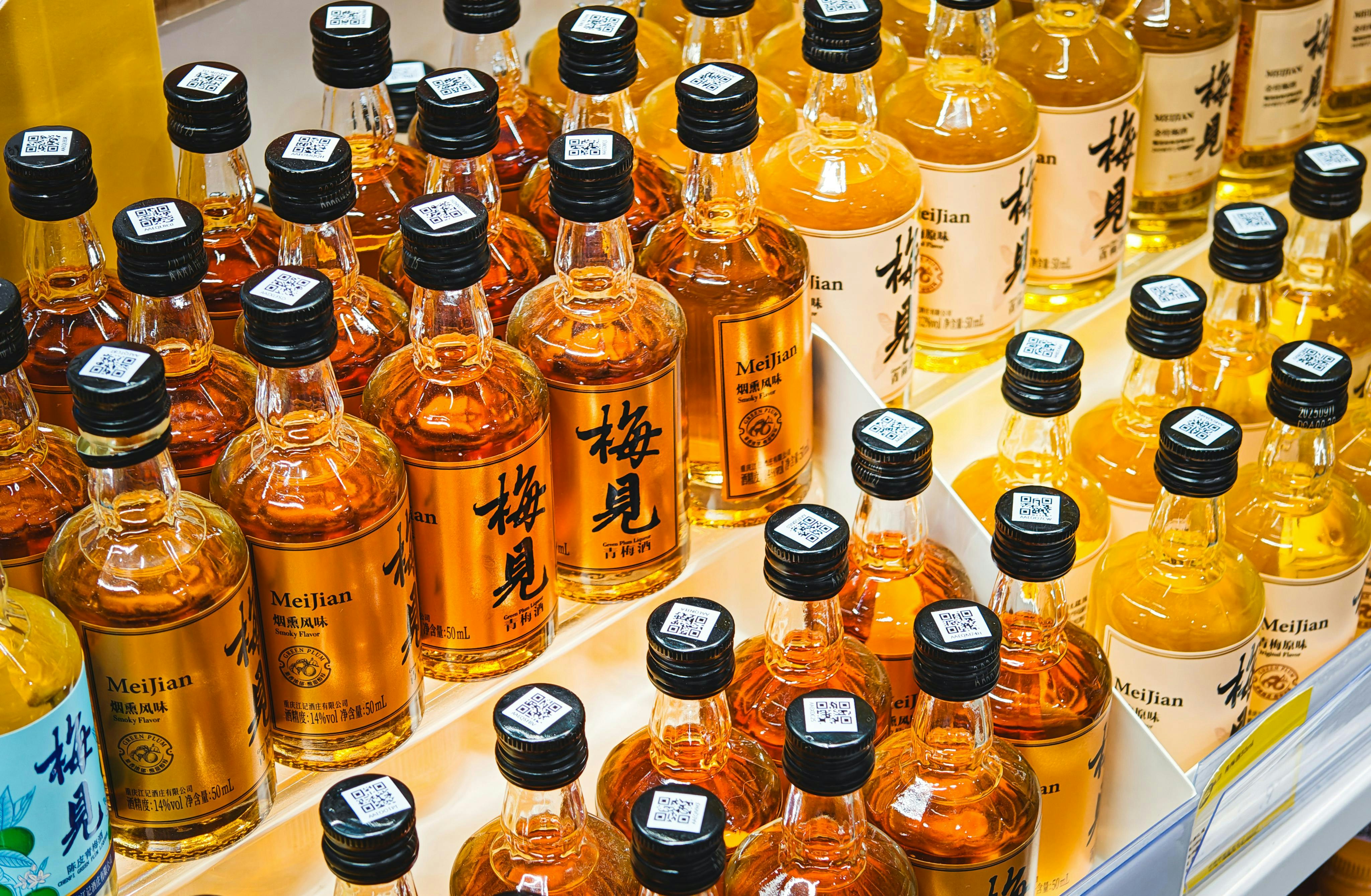 Many small bottles of amber liquid with black caps