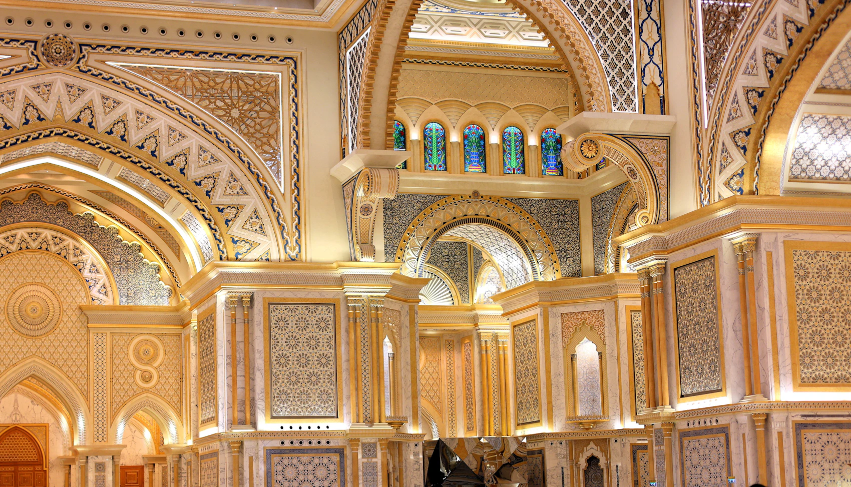 Intricate gold geometric decoration and arches inside Qasr Al Watan