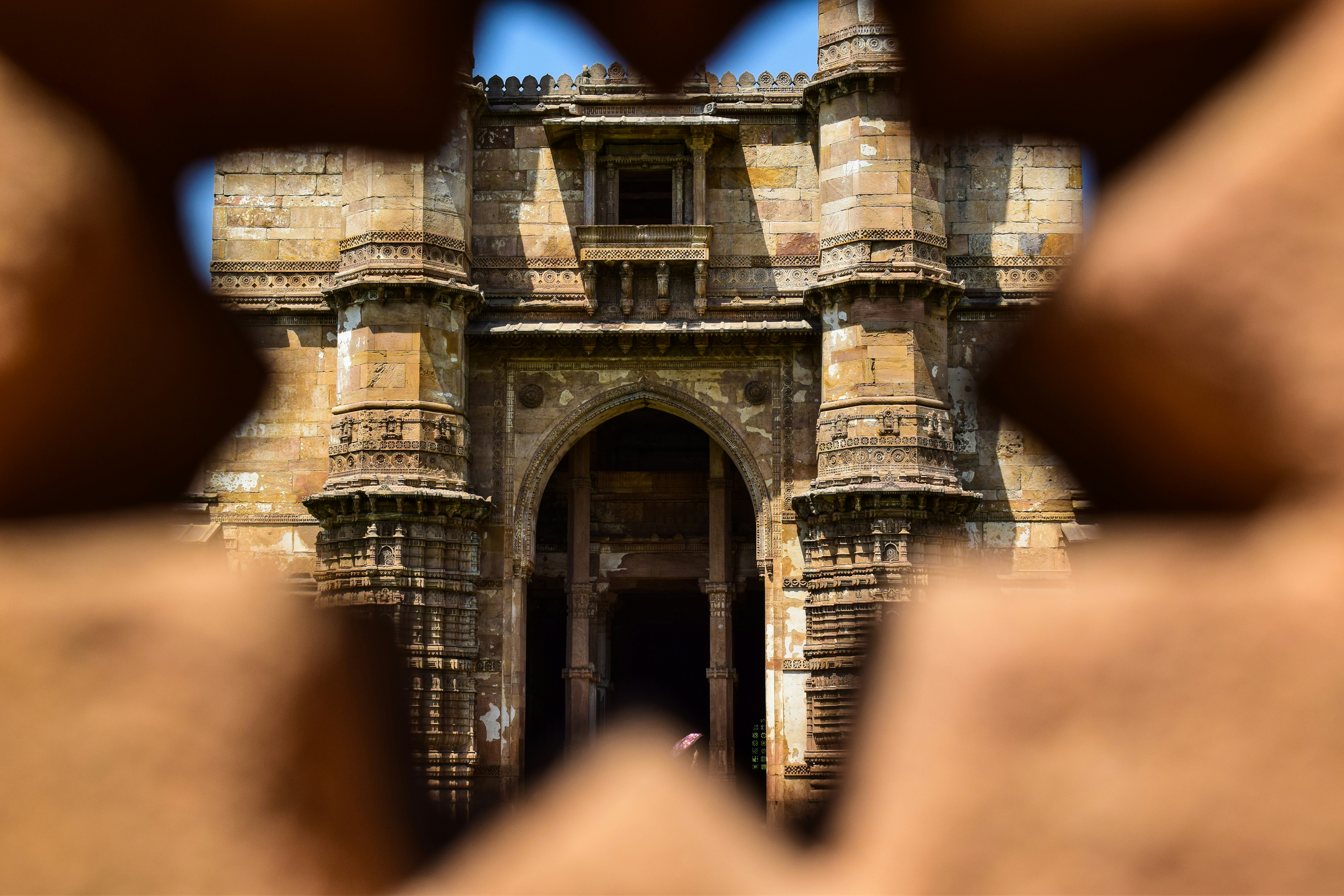 Ancient stone architecture viewed through a star-shaped opening.