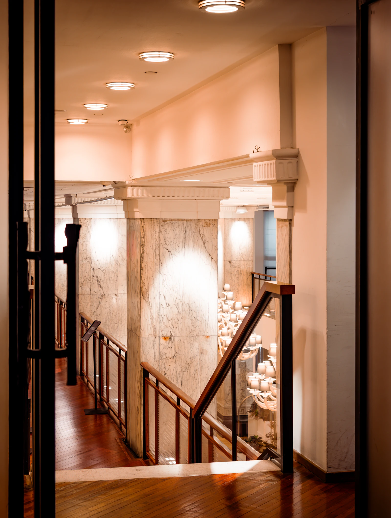 Interior hallway with marble walls and wooden staircase