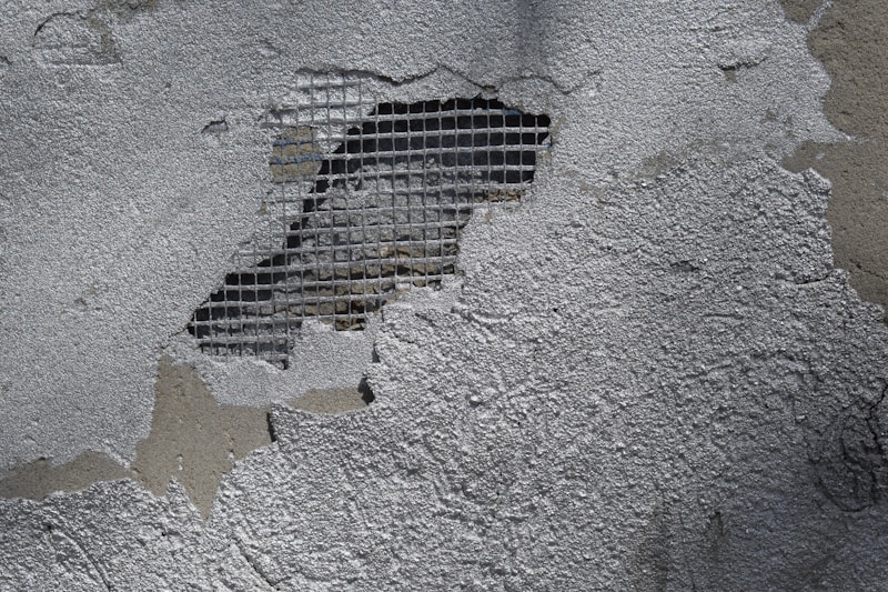 Damaged wall with exposed metal lath