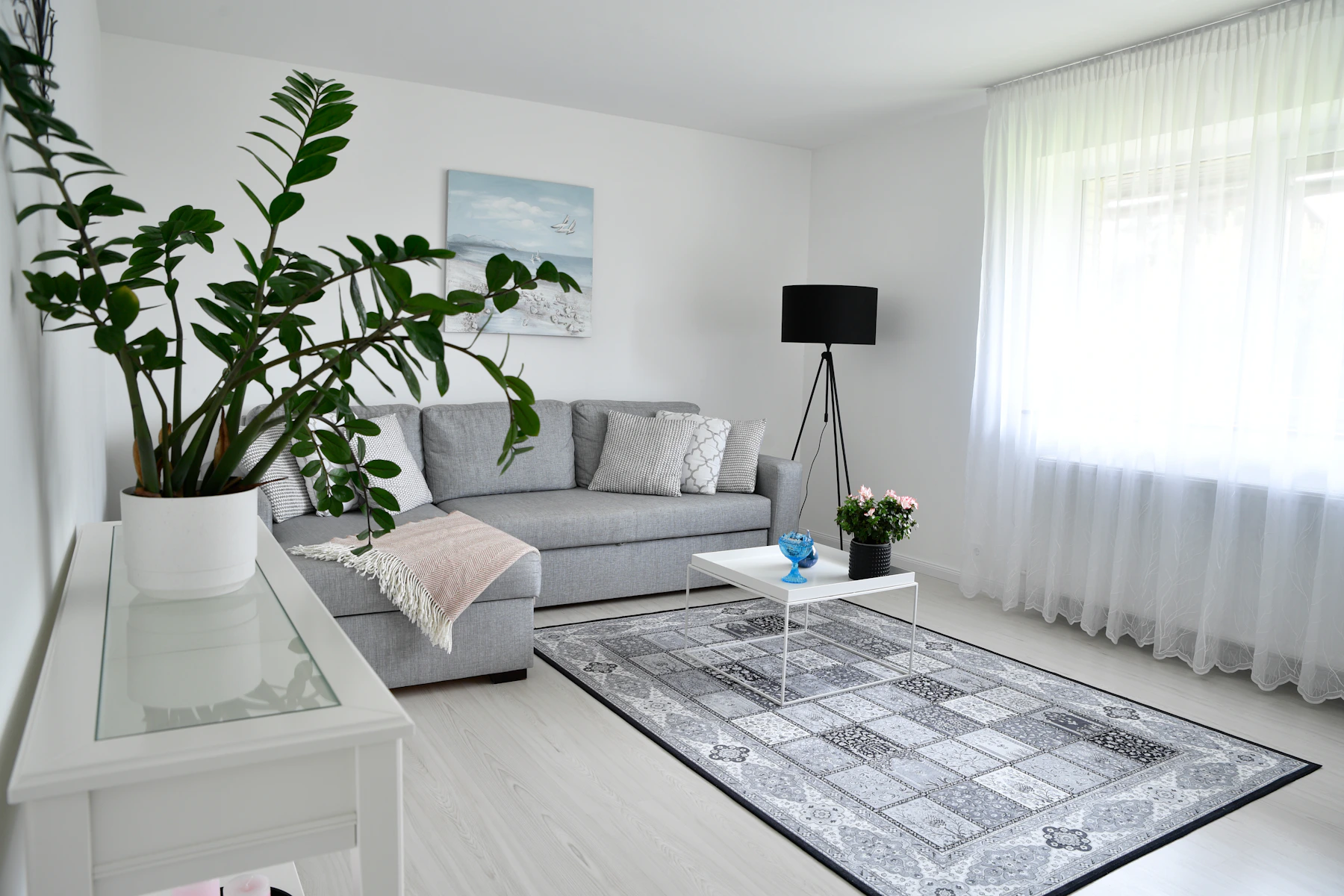 A calm Scandinavian living room styled with large greenery