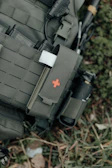 Tactical vest with medical pouch and red cross