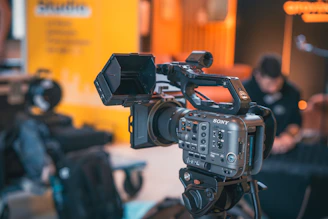 Professional video camera on a tripod with background blur