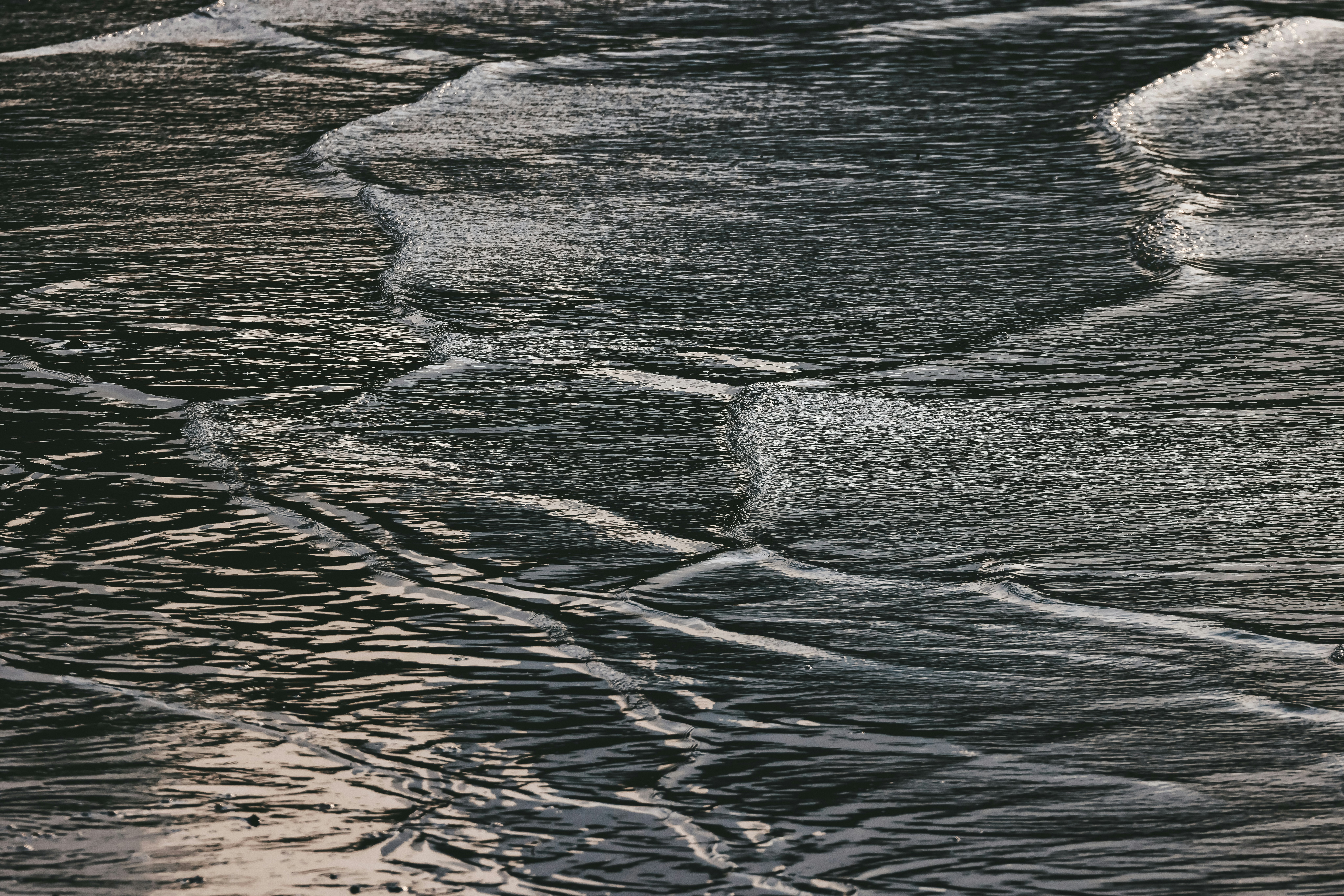 Abstract patterns of dark and light sand textures.
