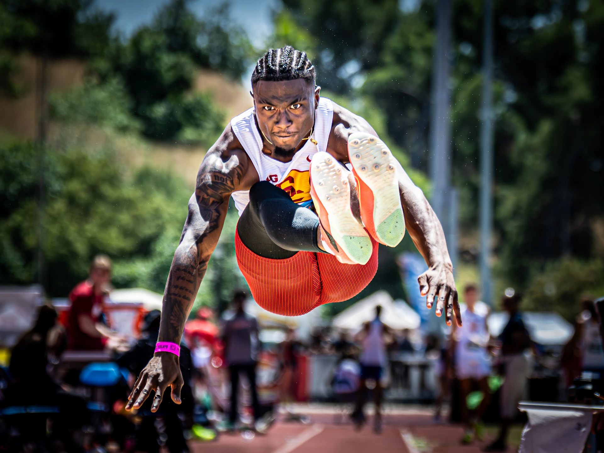 An athlete in mid-air during a long jump competition