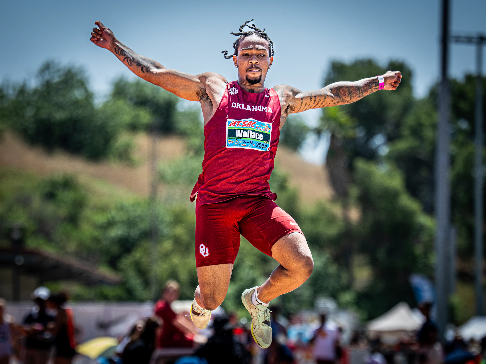 Athlete in mid-air during a long jump competition