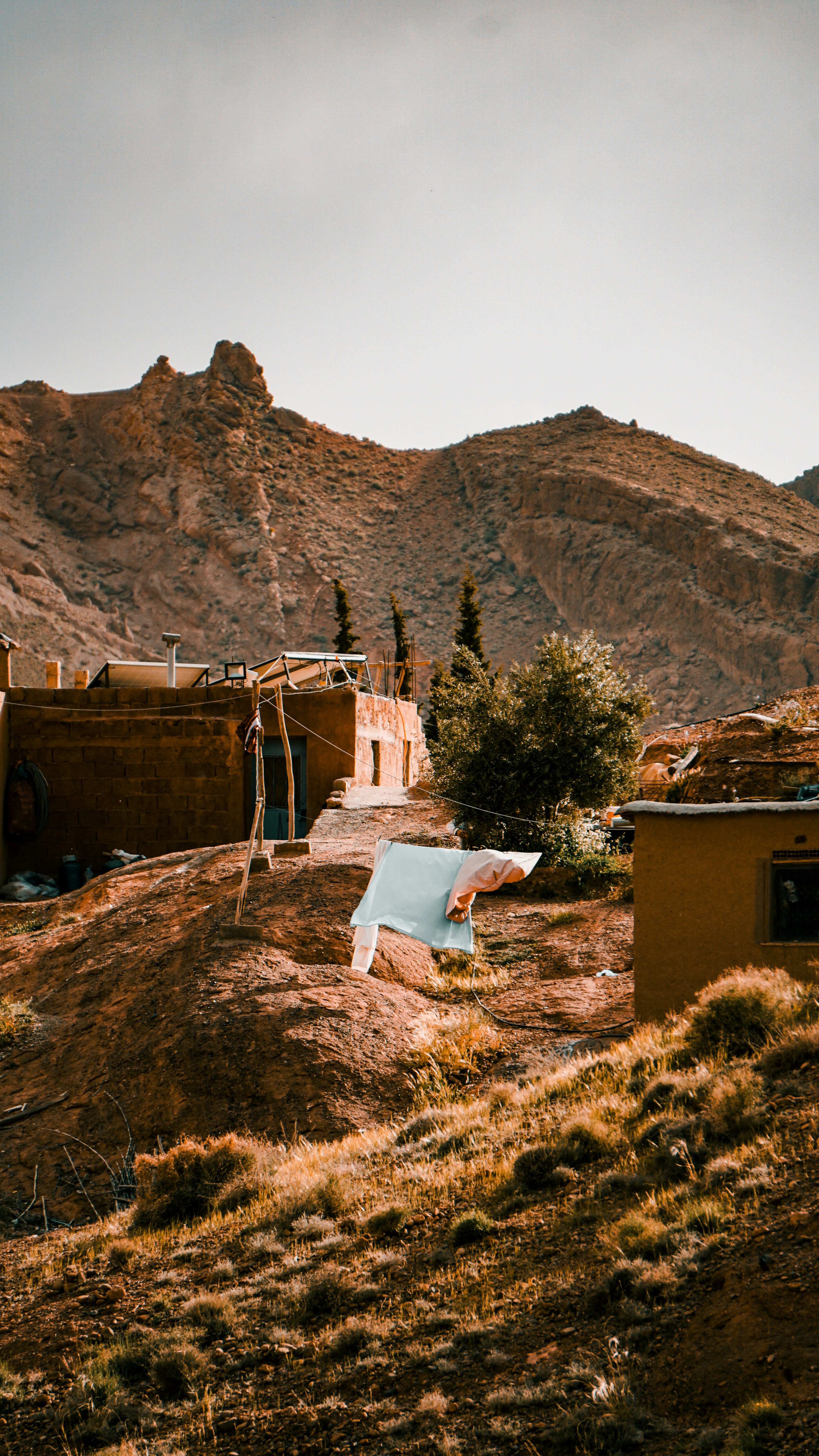 Traditional village nestled in a rocky mountain landscape.