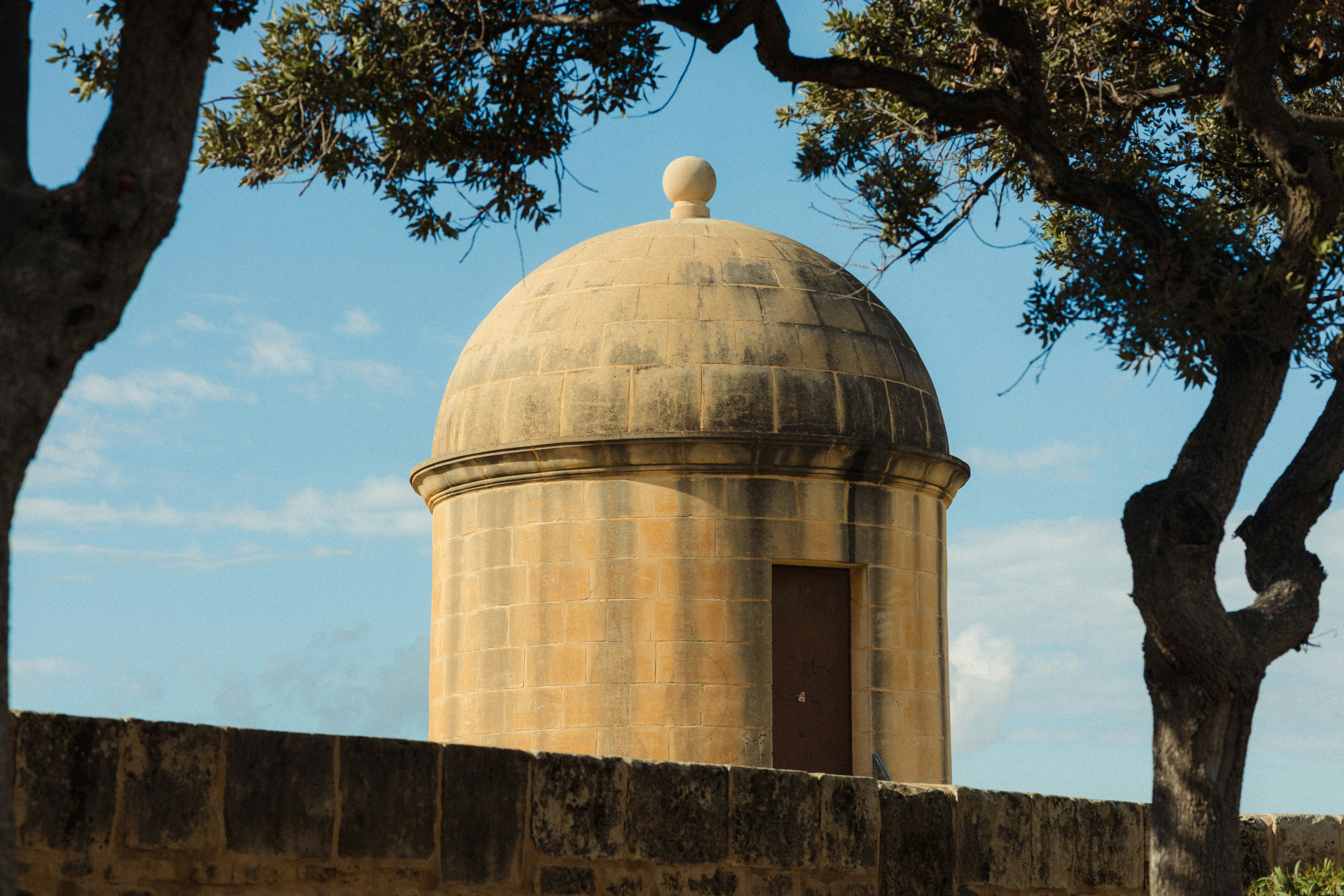 Stone turret with a small door and domed roof.