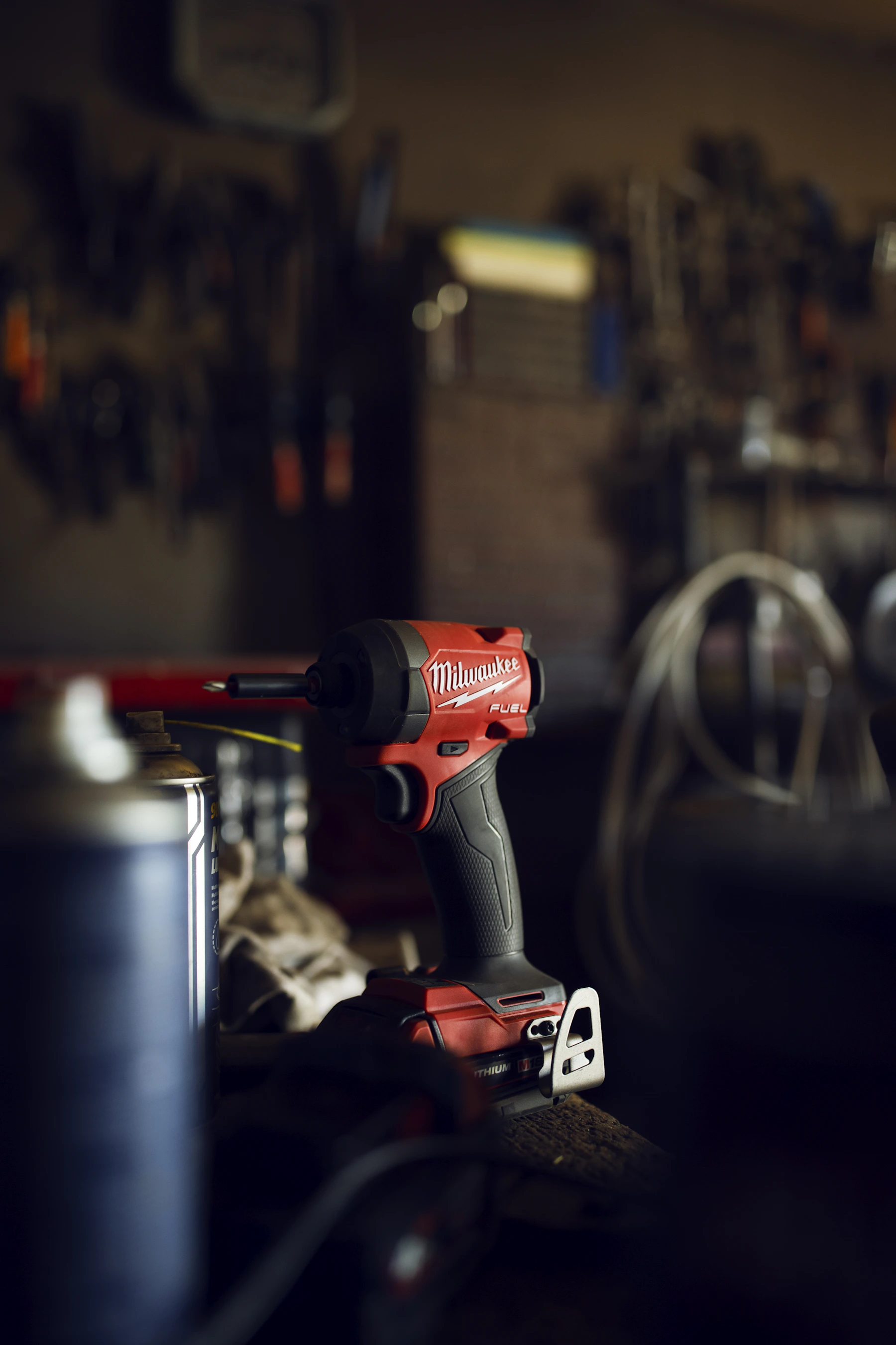 Cordless impact driver placed on a workshop workbench