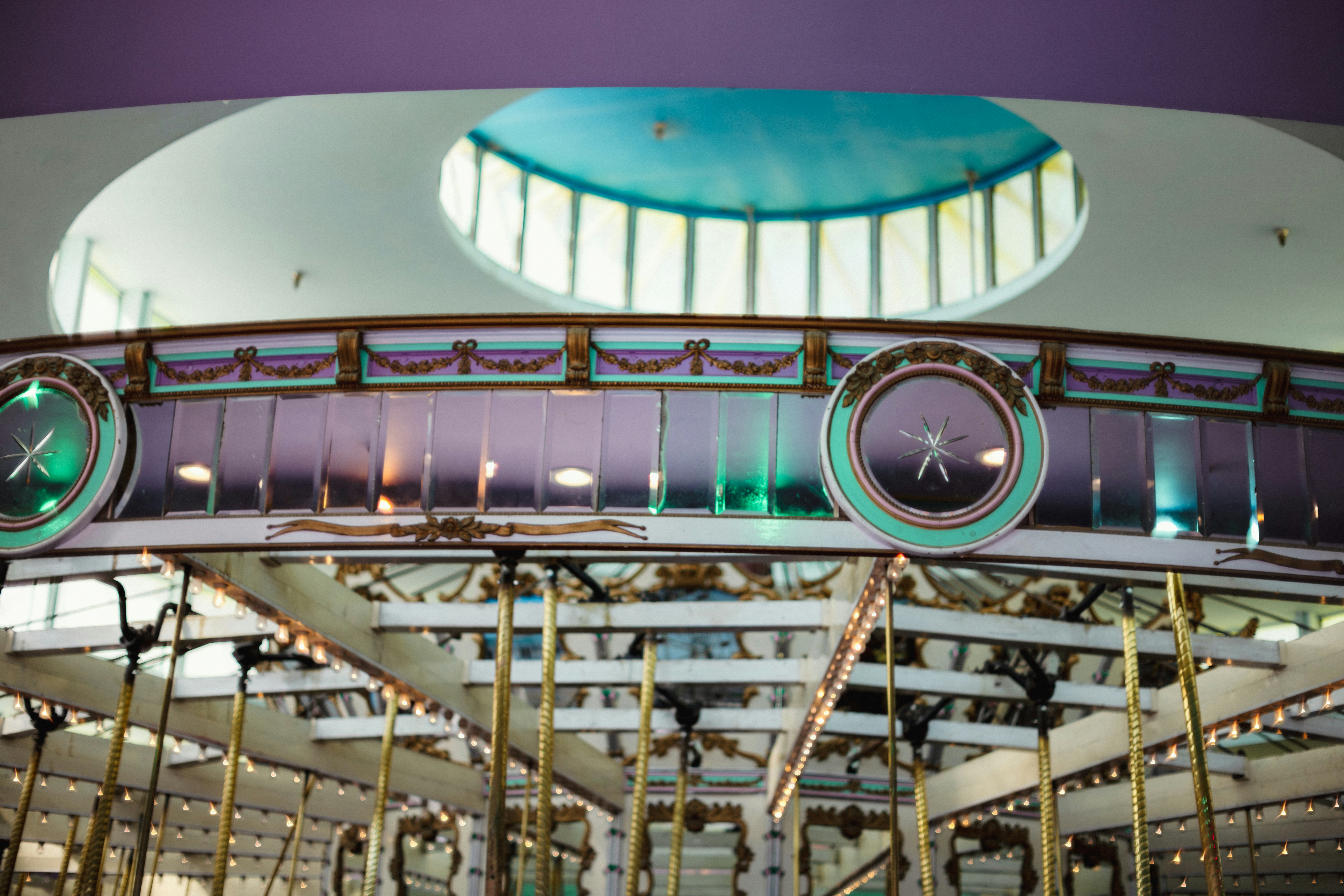 Close-up of an ornate carousel interior with lights.