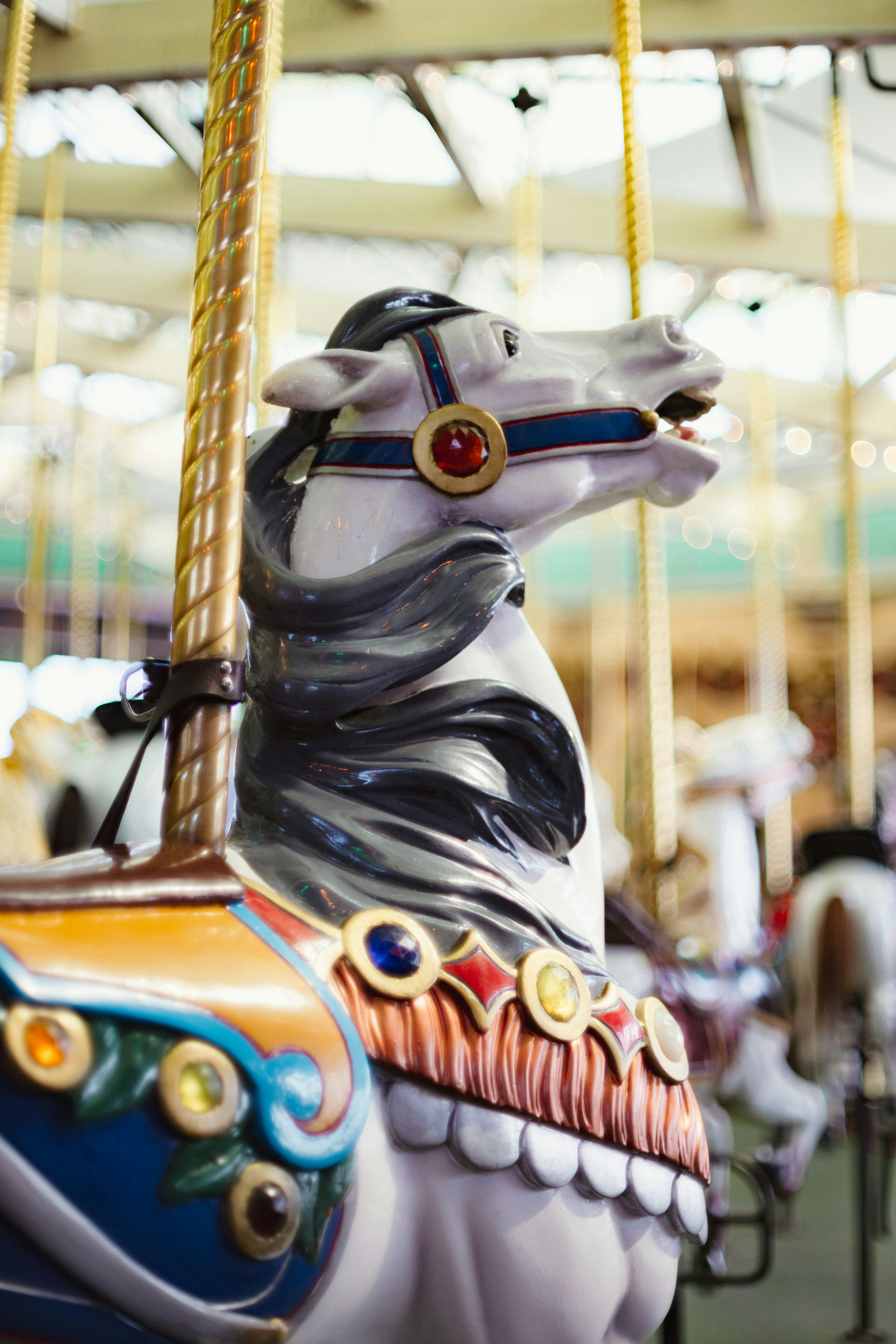 A decorated carousel horse with a mane
