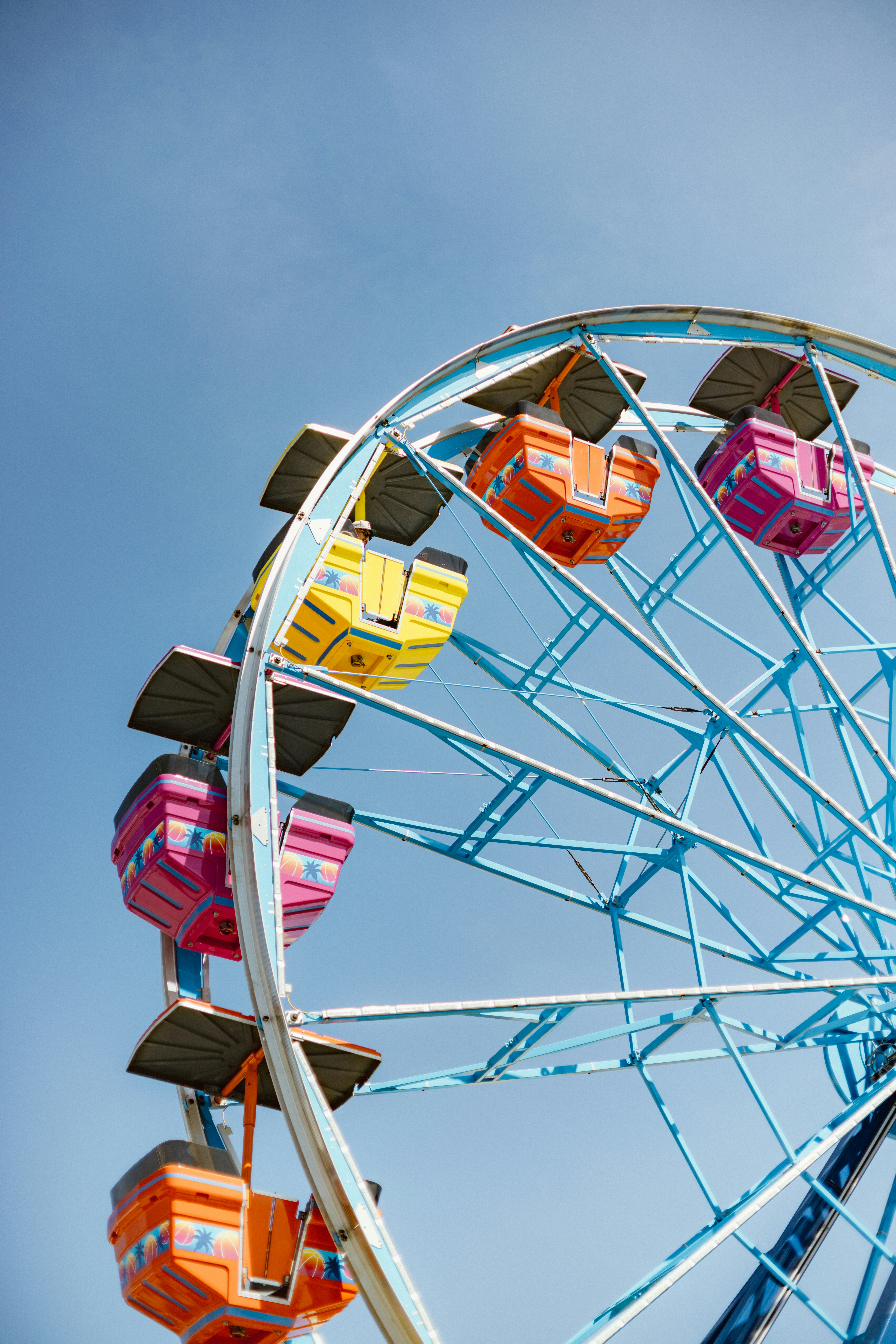 Colorful ferris wheel against a clear blue sky