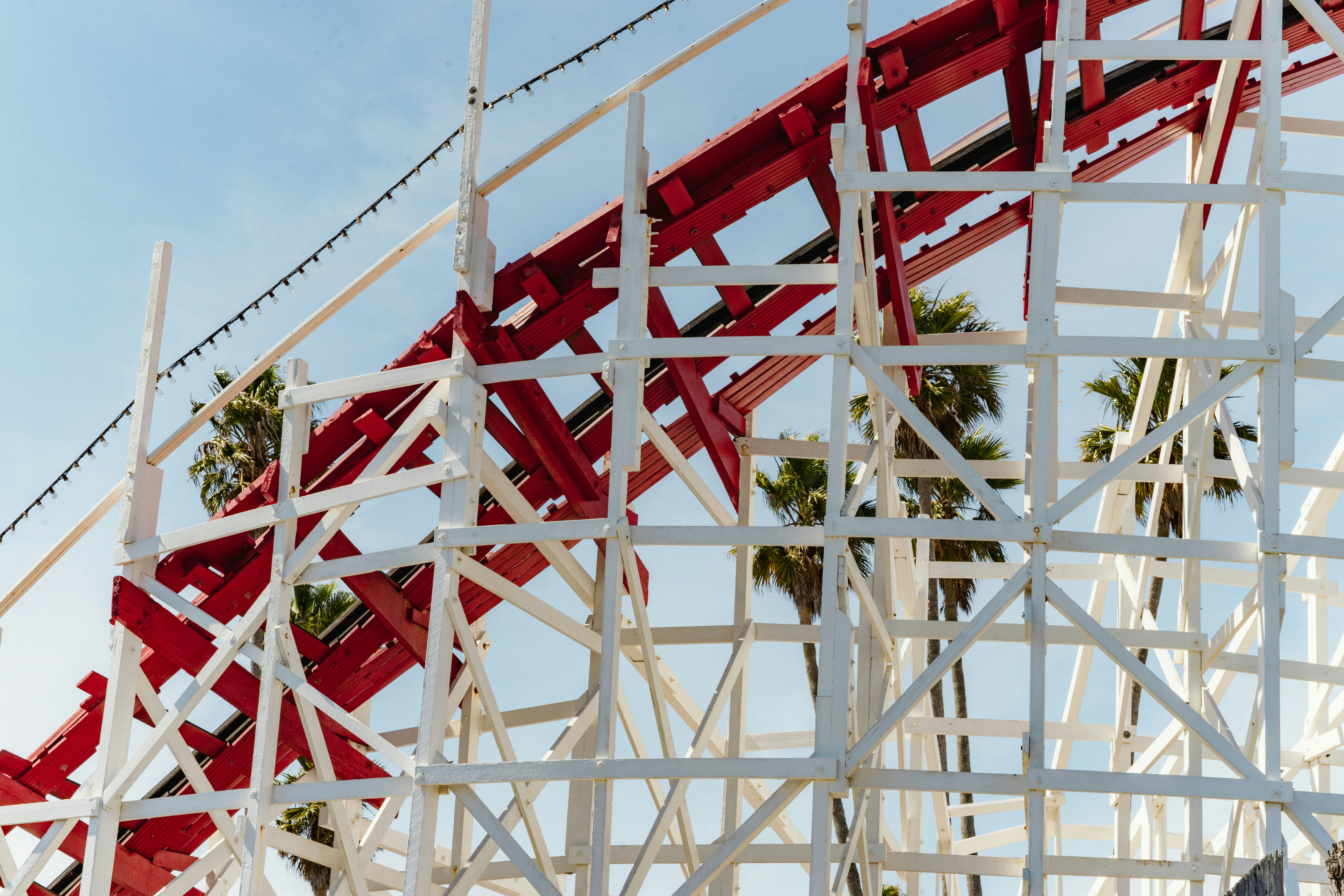 Roller coaster structure with palm trees and sky