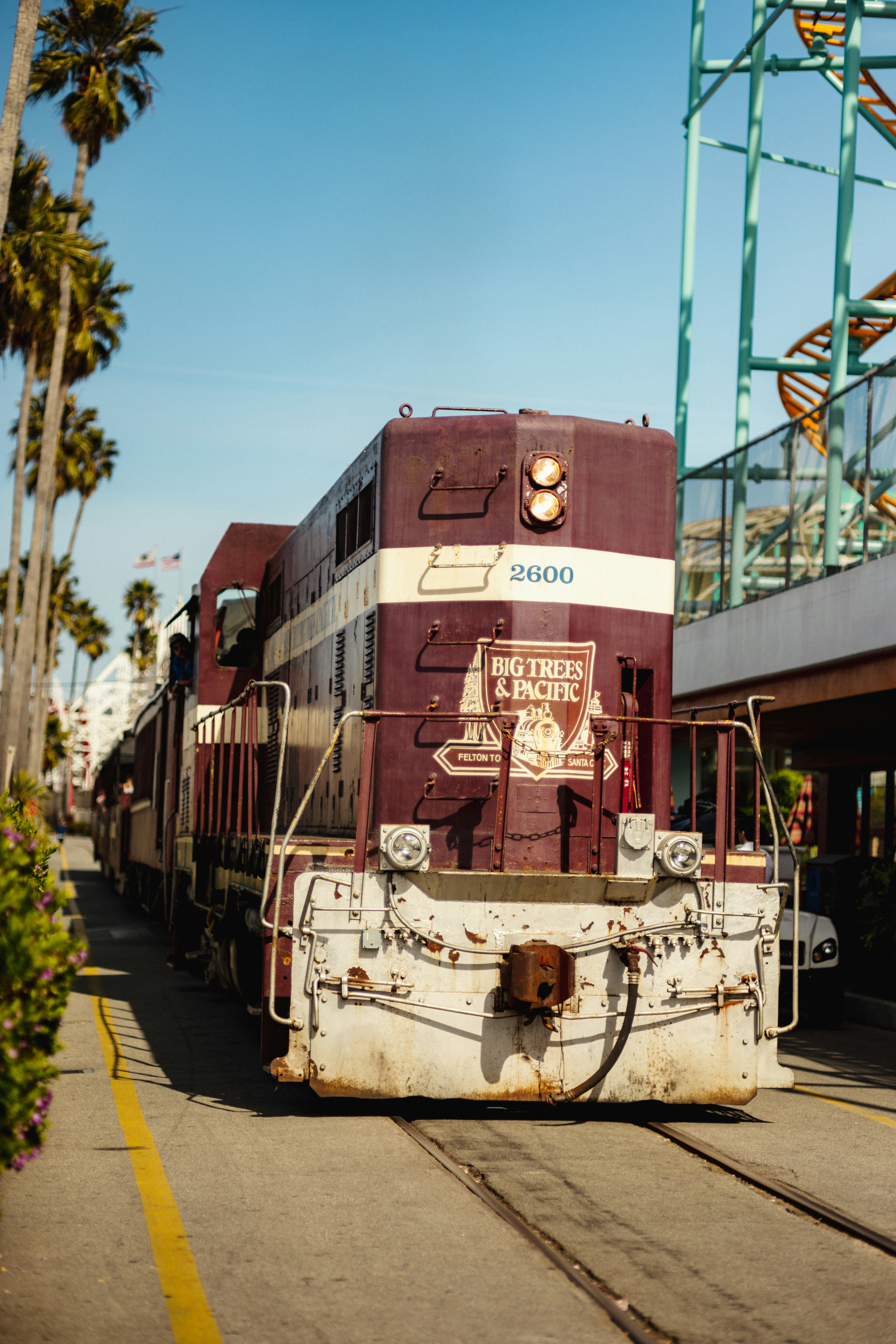 A maroon and white train engine on tracks