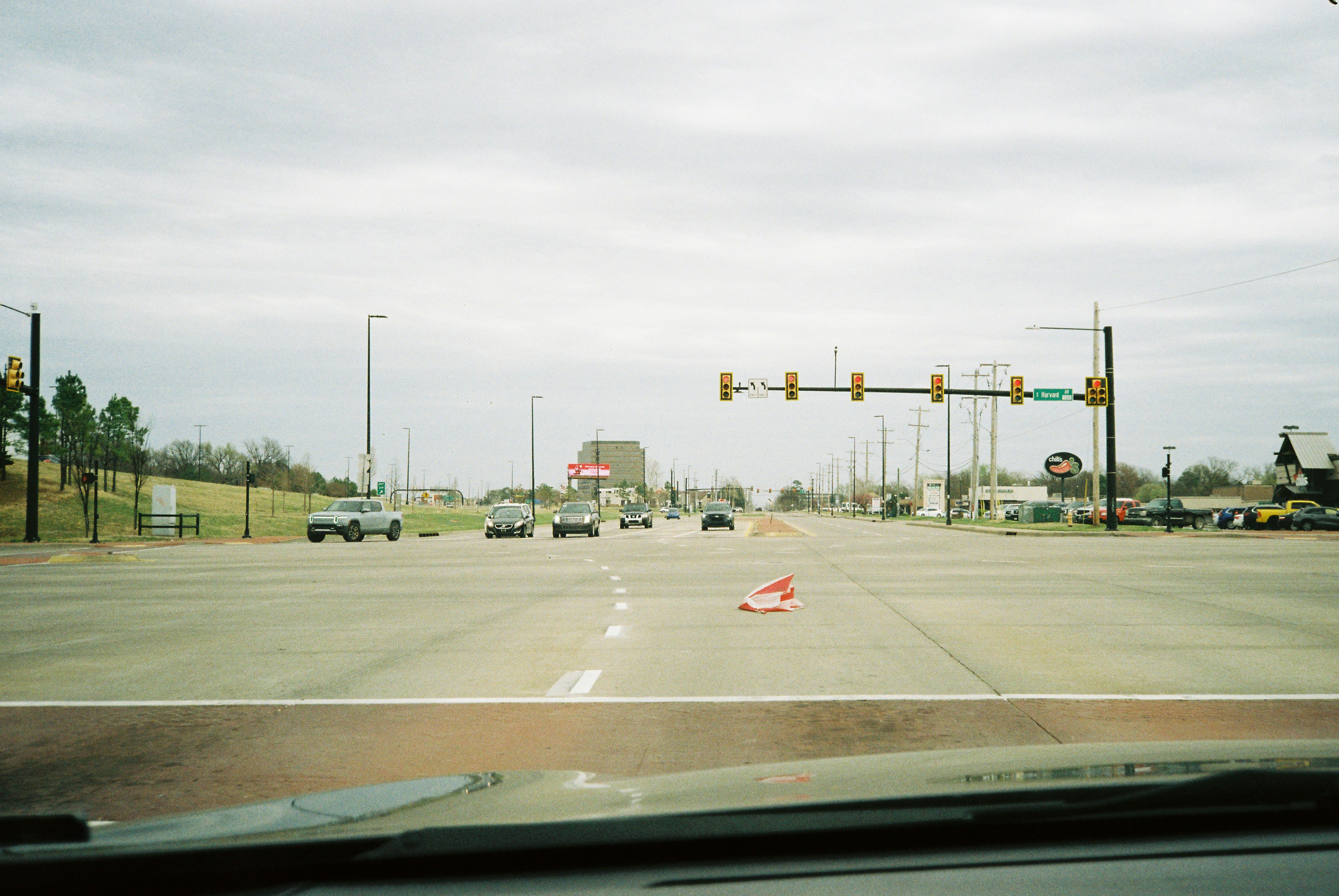 Cars on a wide street with traffic lights