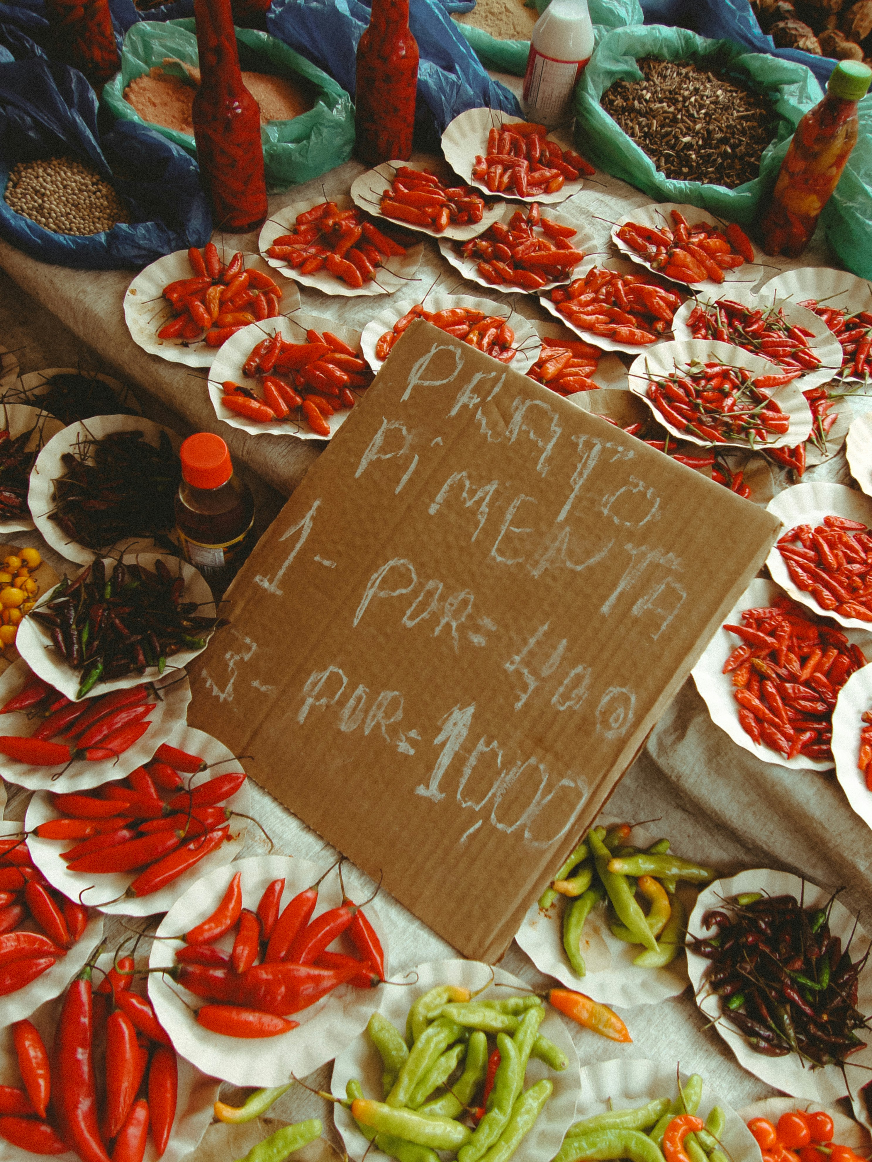 Red and green chili peppers displayed at a market.