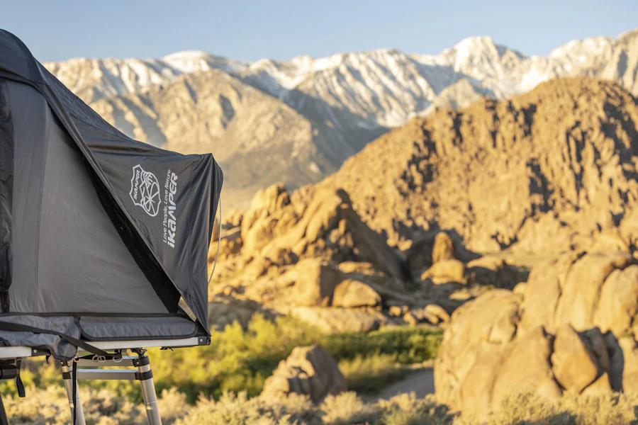 Tent pitched in a rocky landscape with mountains