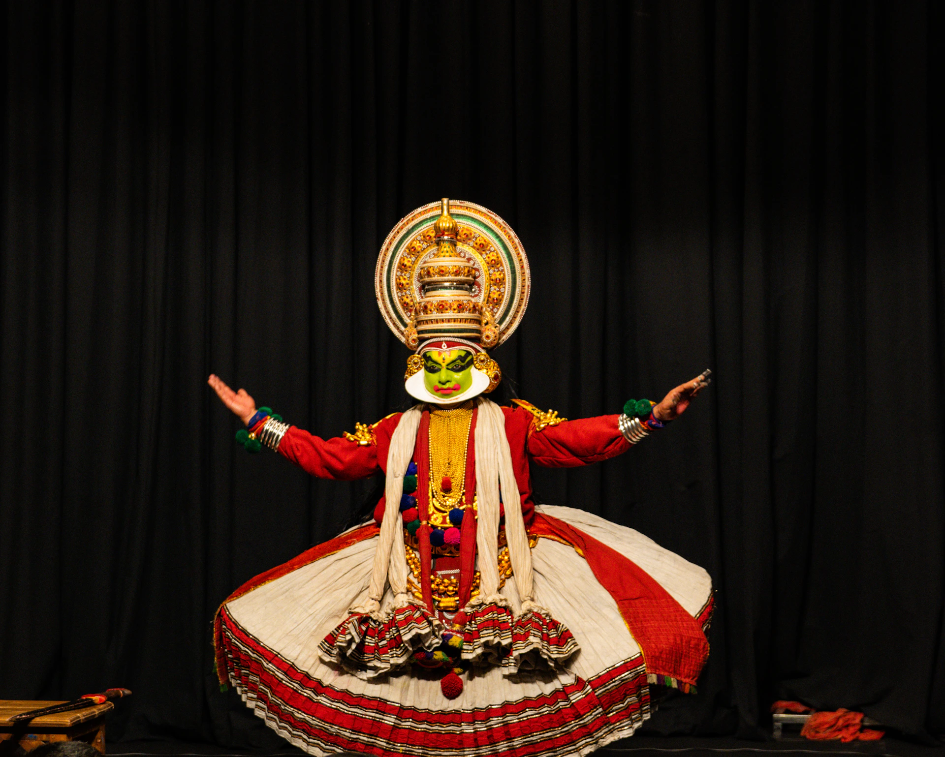 Kathakali dancer in elaborate costume and makeup performs