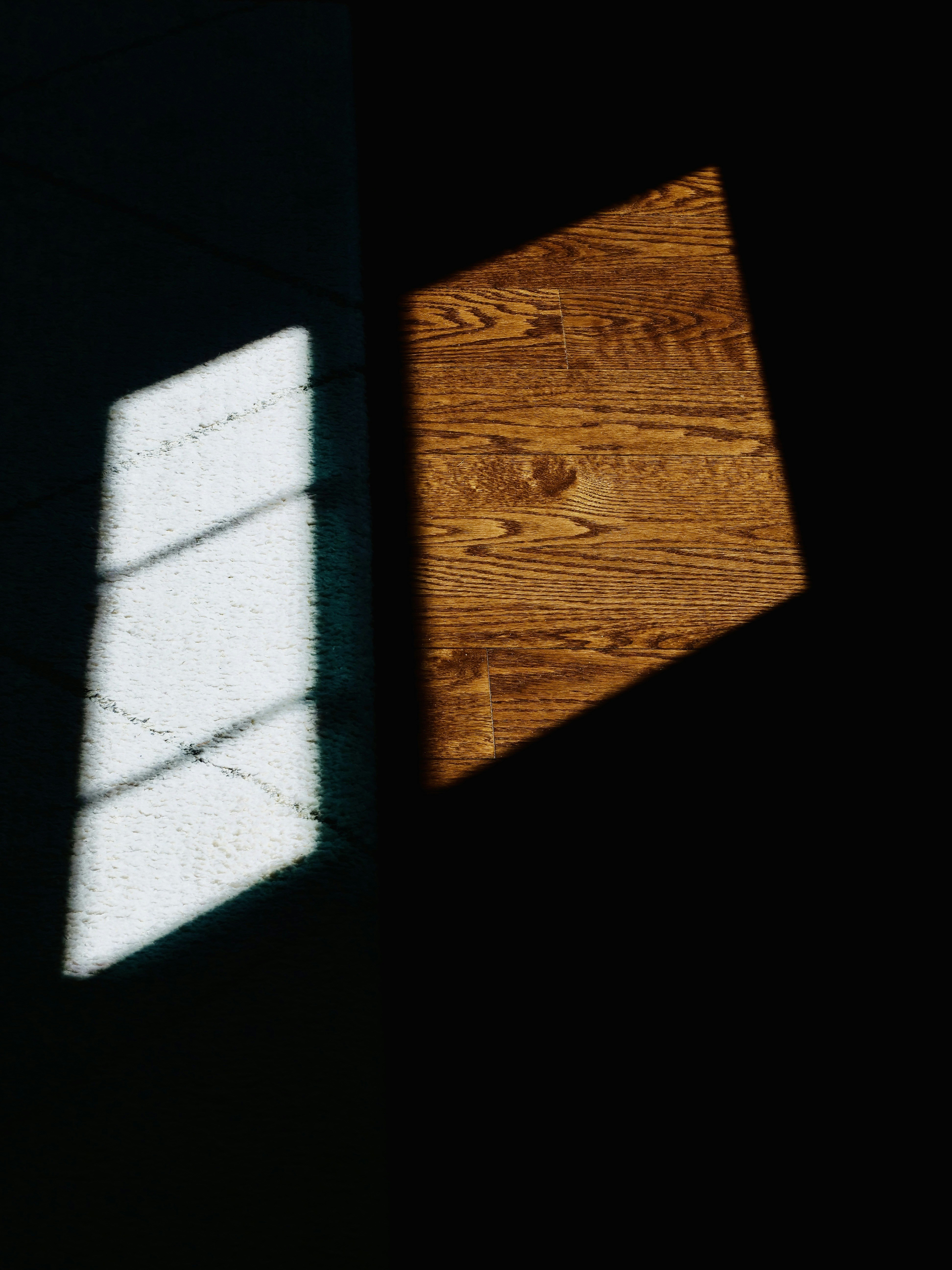 Sunlight streams through a window onto a wooden floor.