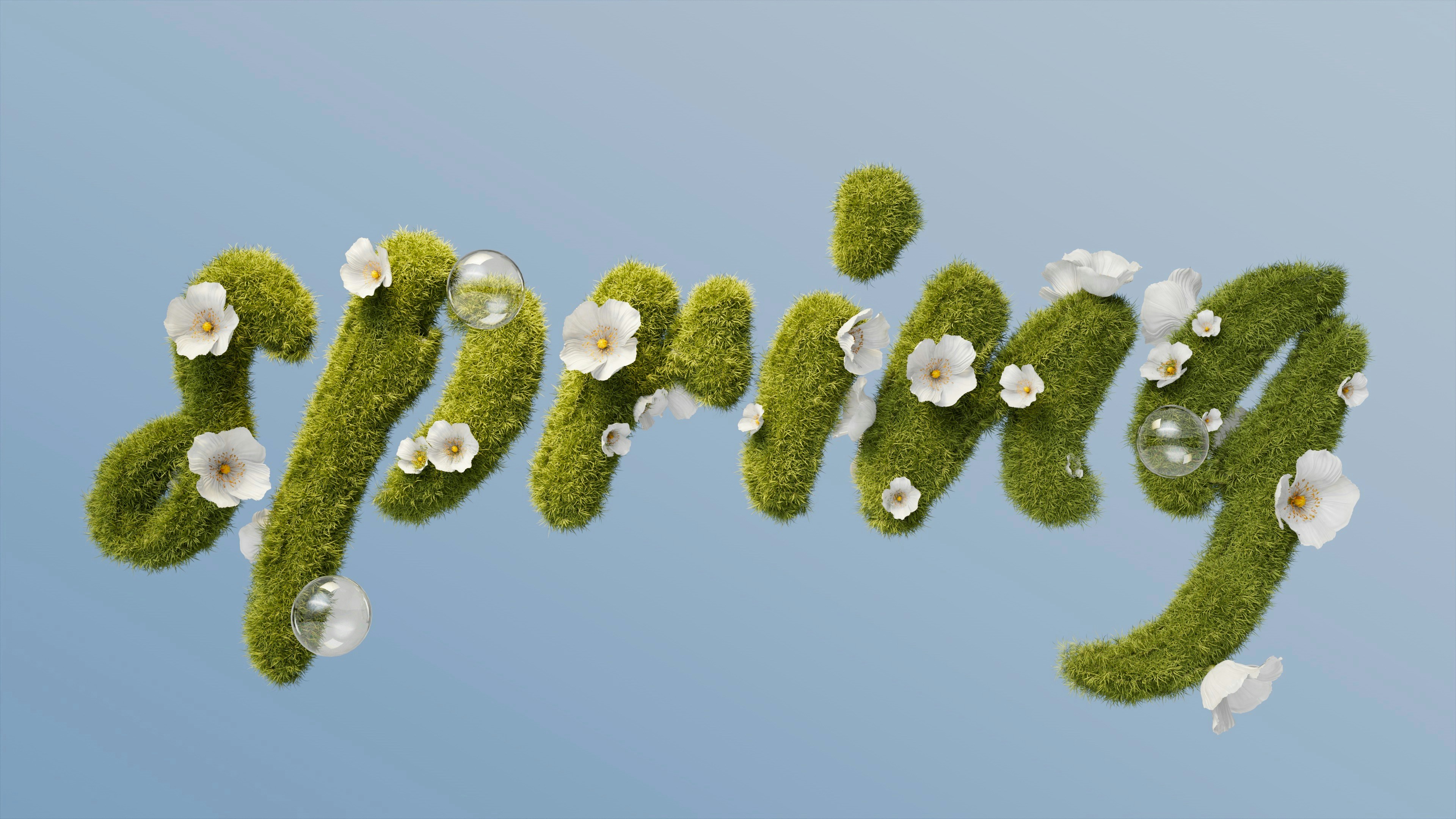 Green moss letters spelling out "spring" with flowers