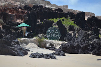 Sign for spa amor on a rocky beach