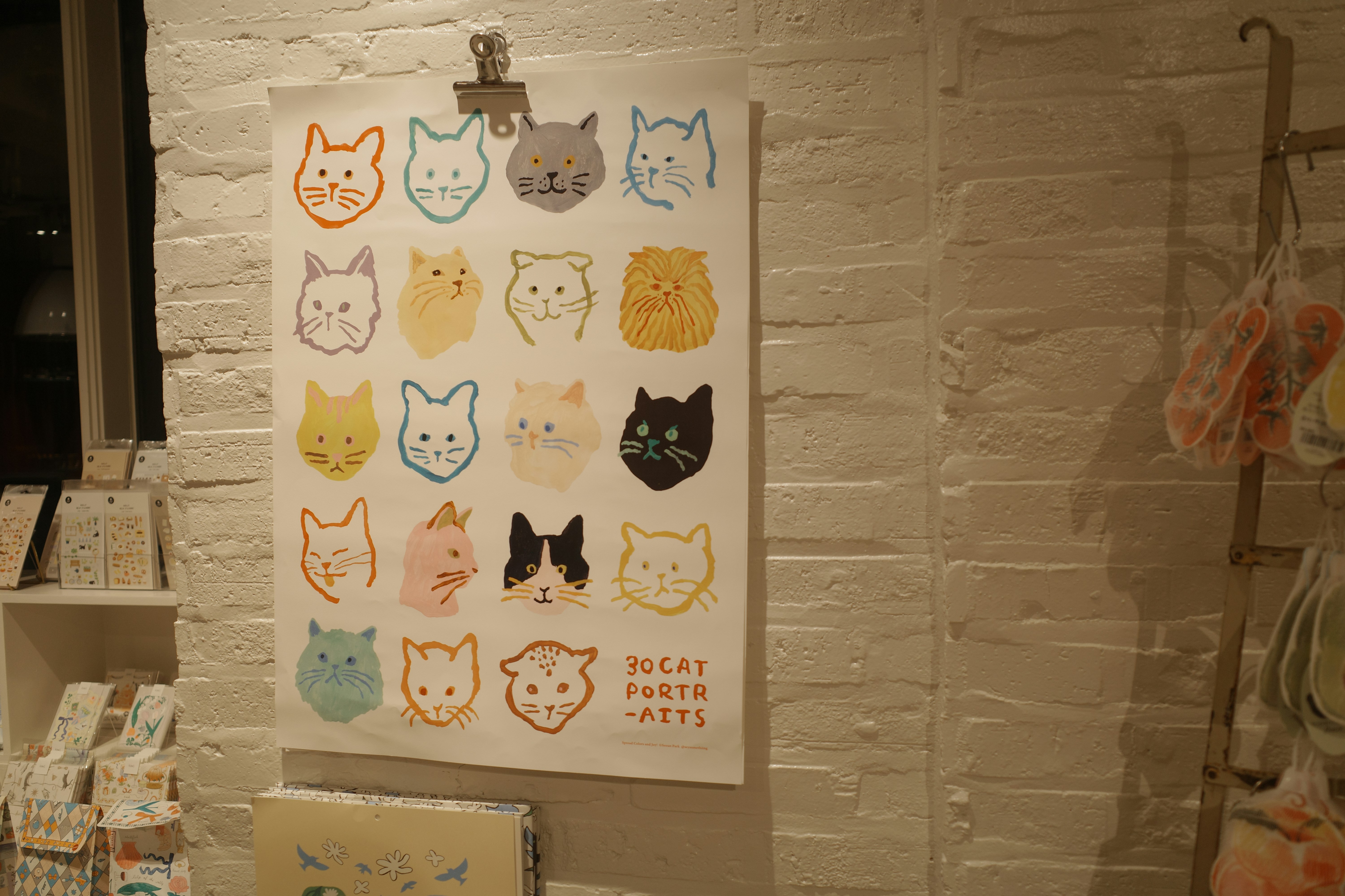 Poster with colorful cat faces in rows