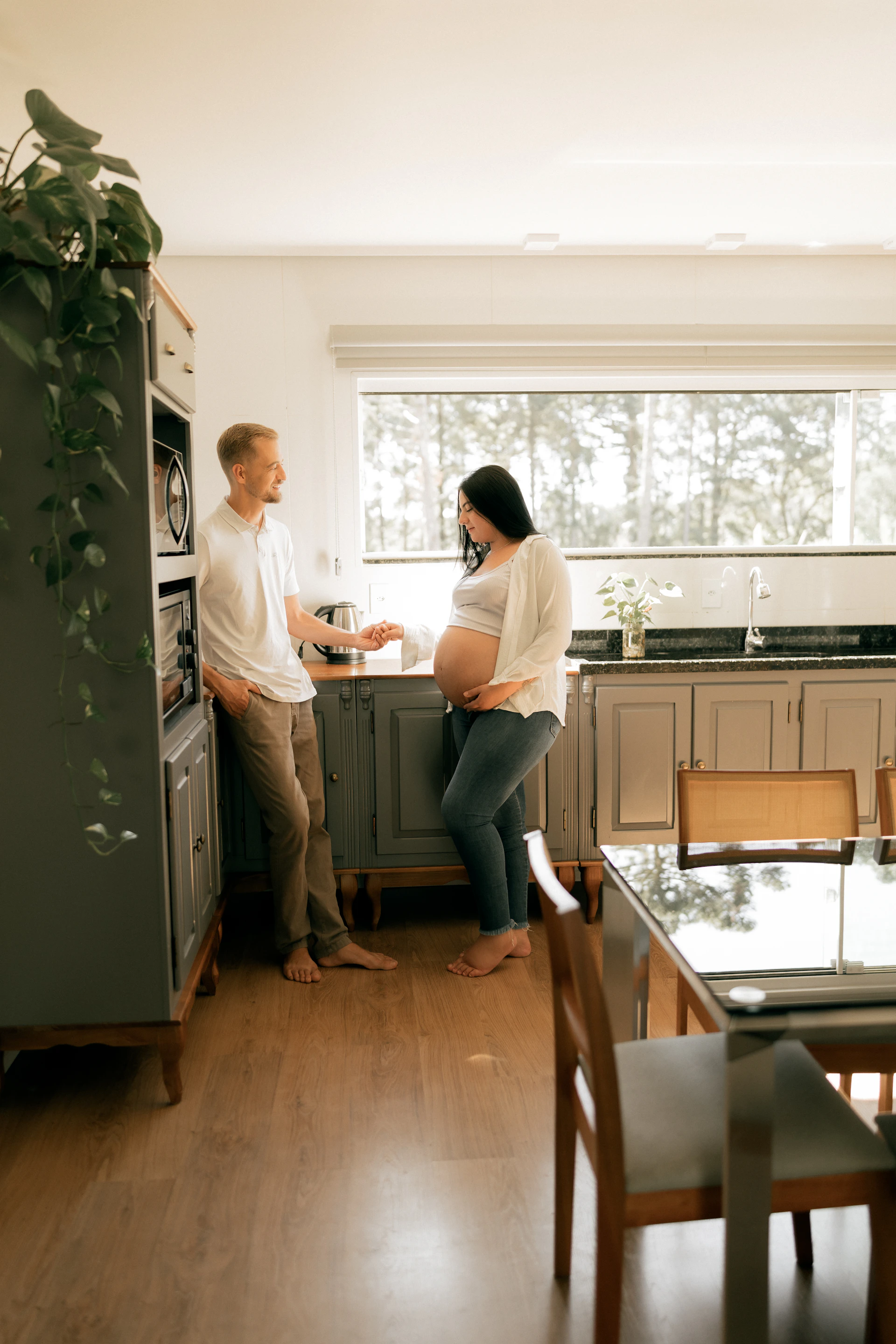 A pregnant woman and a man in a kitchen