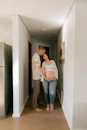 Couple embracing in hallway, woman is pregnant