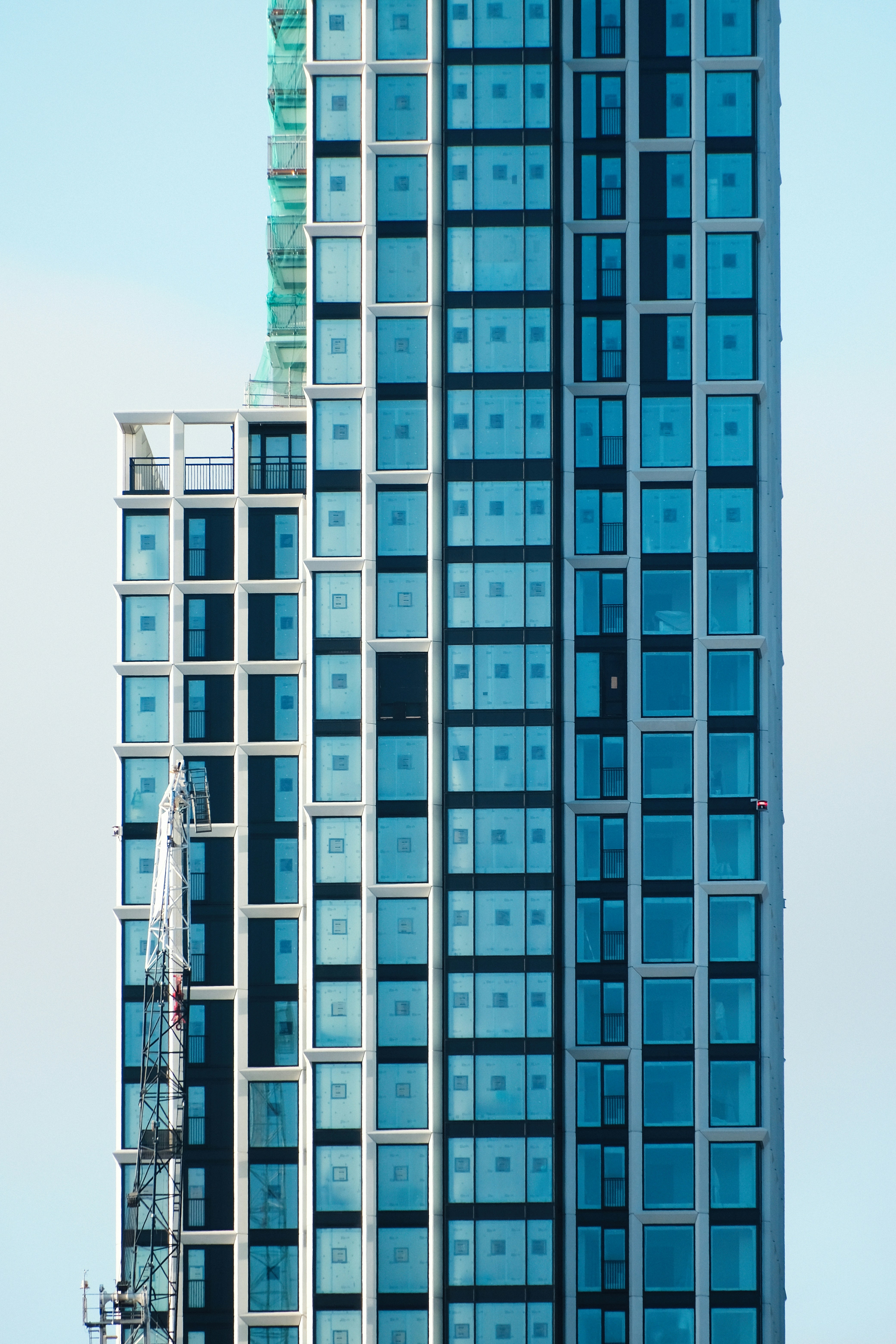 Modern skyscraper with glass facade against blue sky