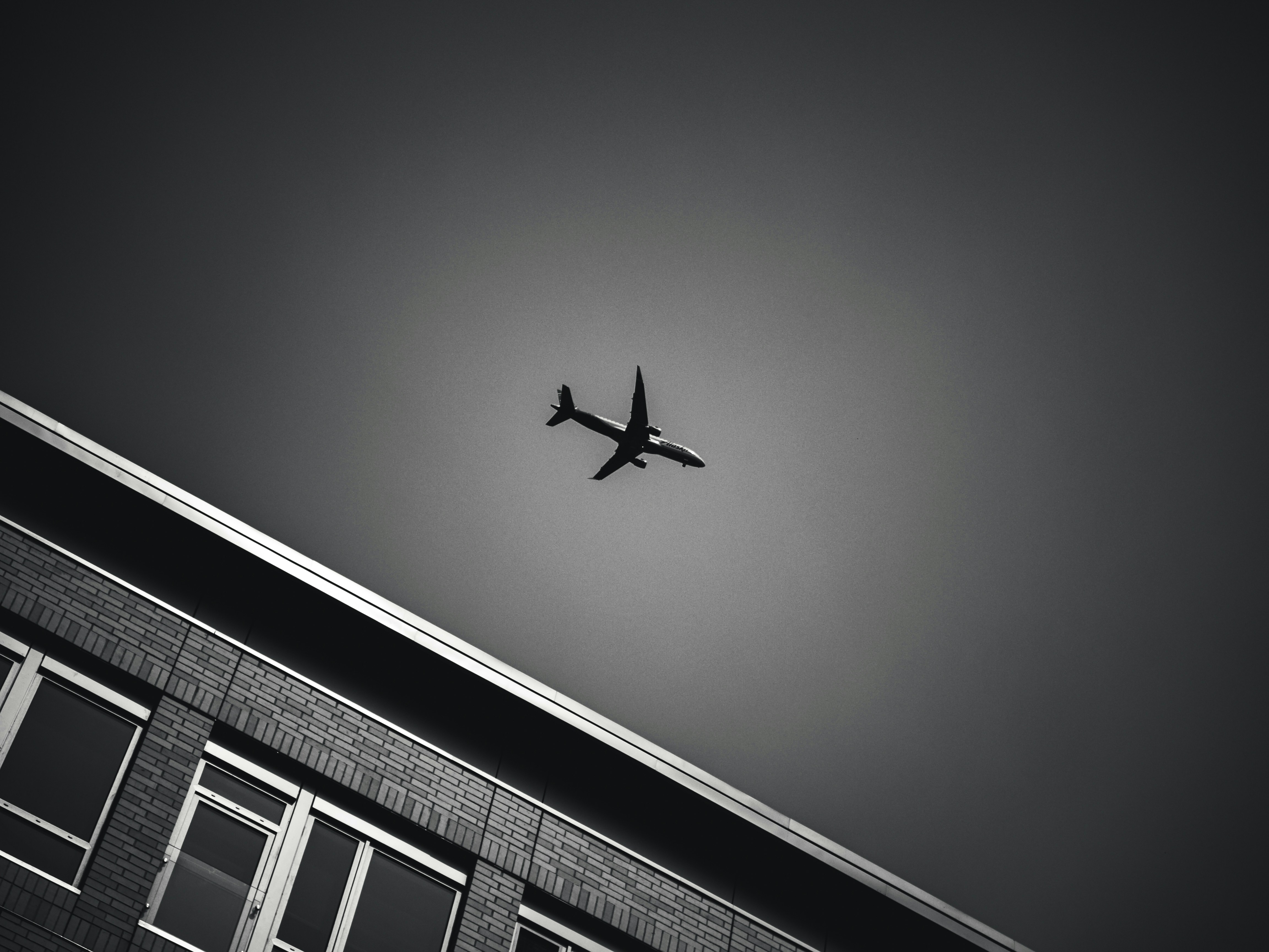 Black and white airliner over the city.