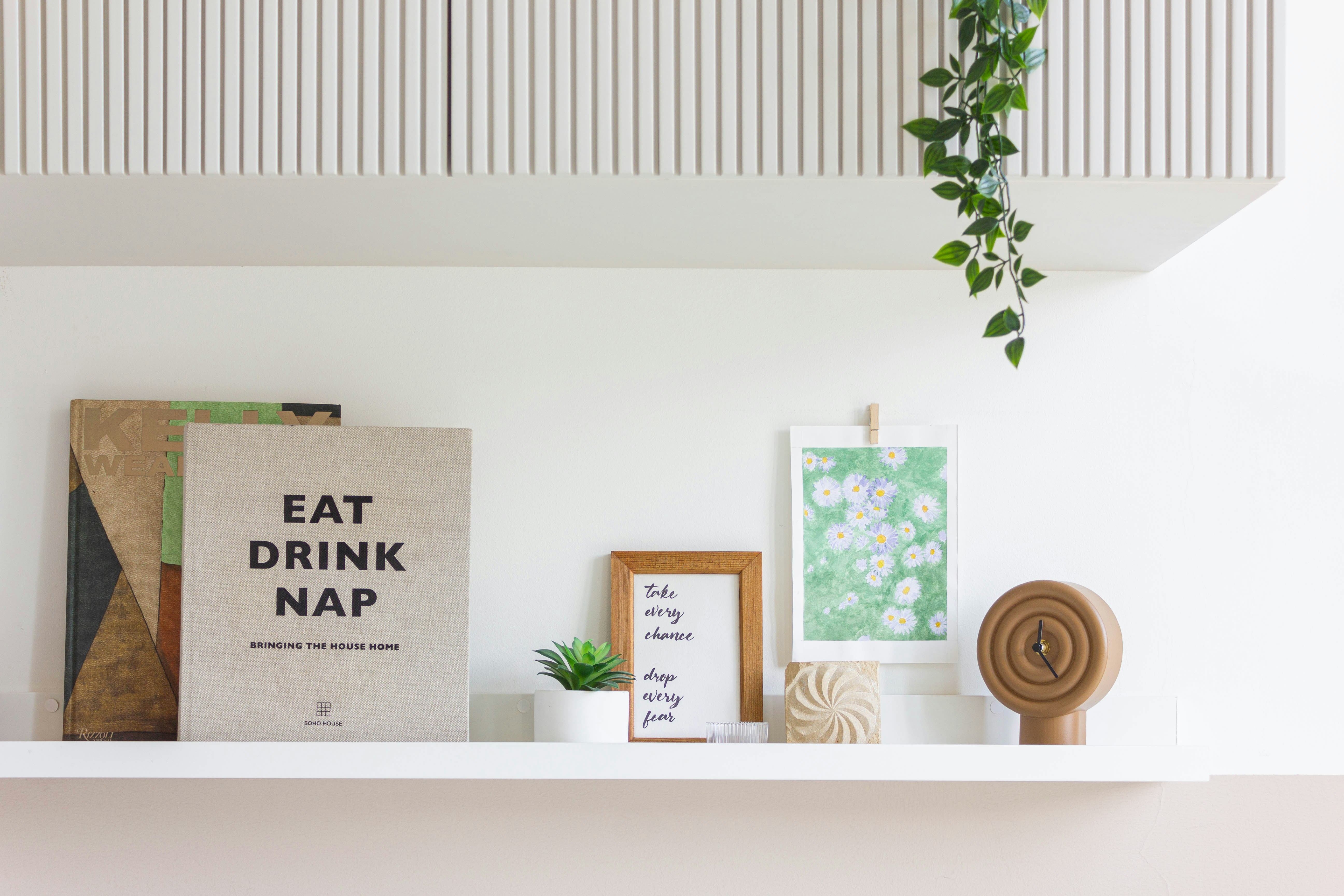 Shelf with books, art, and decor