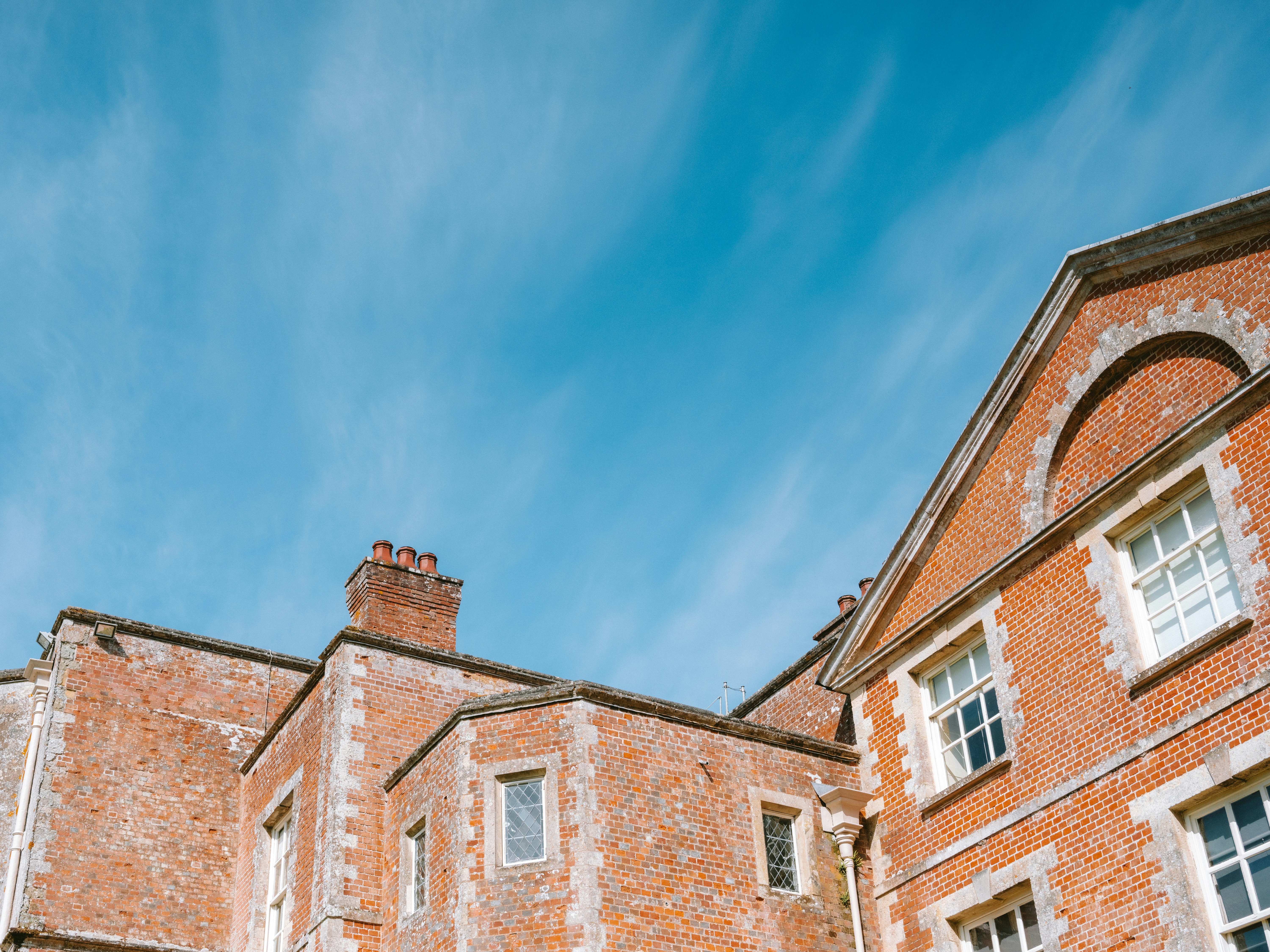 Brick building with white trim against blue sky