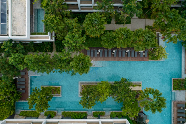 Aerial view of a resort with pool and lush greenery