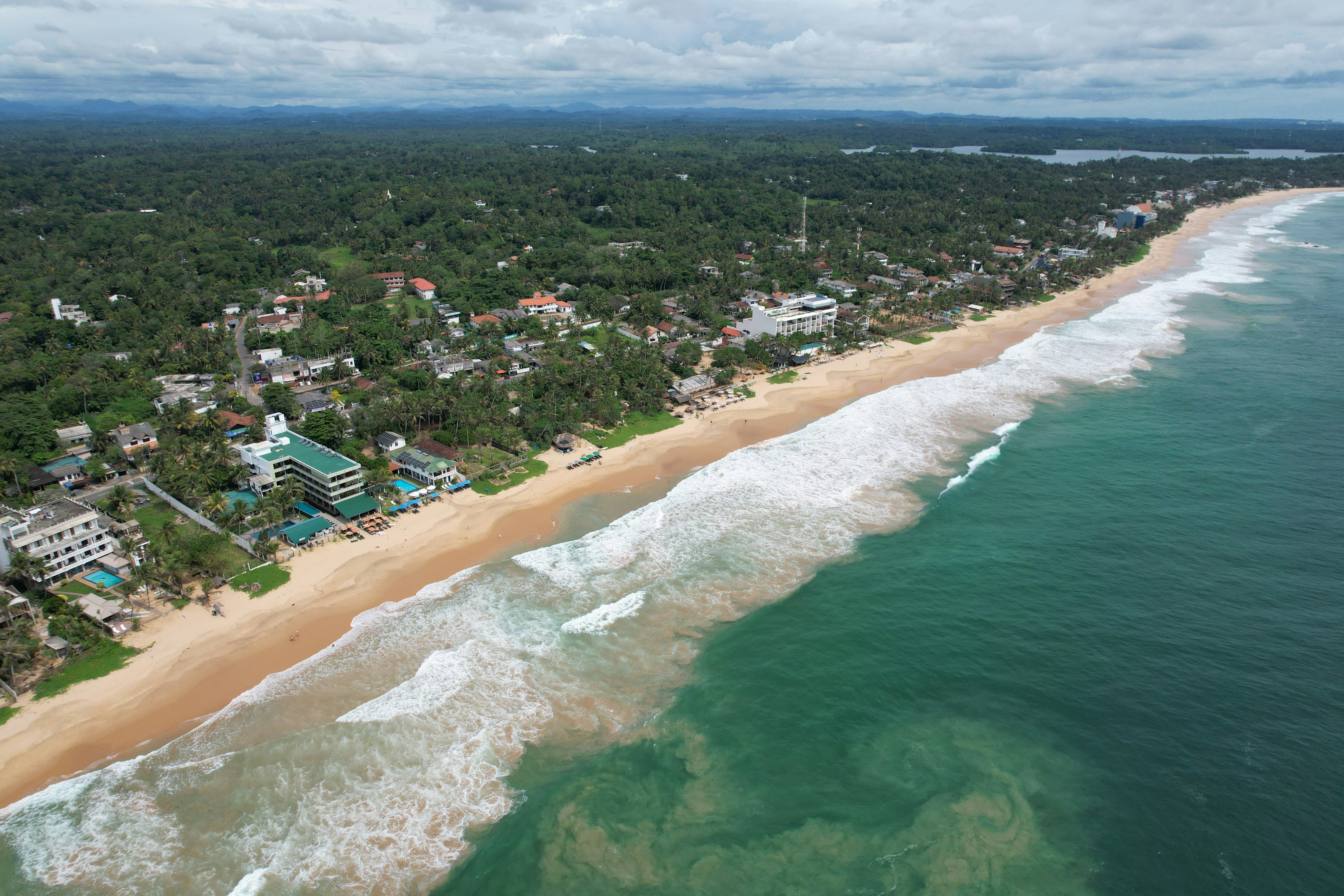 Tropical coastline with sandy beach and turquoise ocean waves